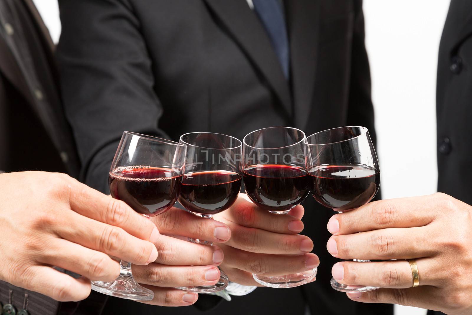 Close-up of human hands cheering up with flutes of wine