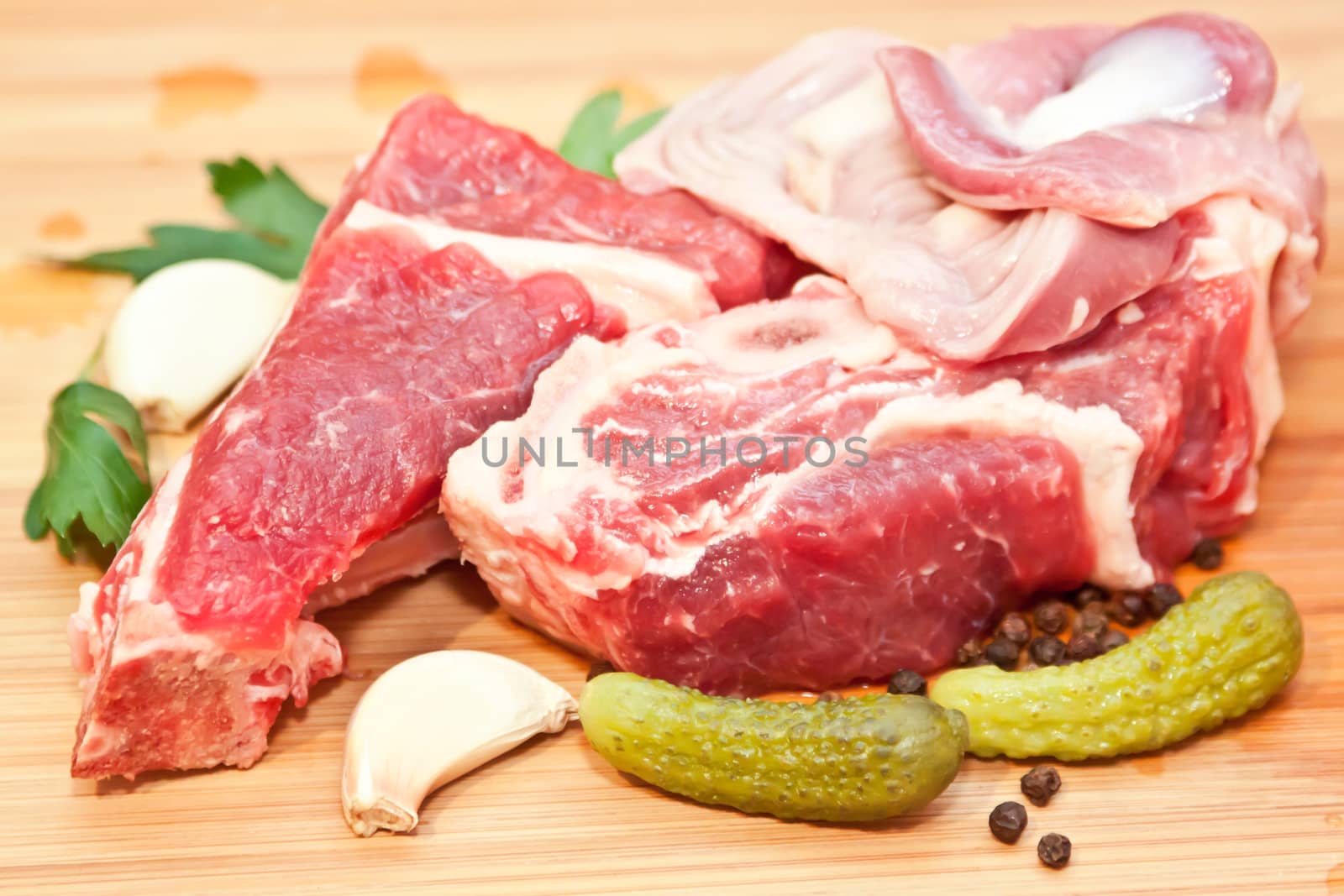 Raw beef with spices and vegetables on the cutting board
