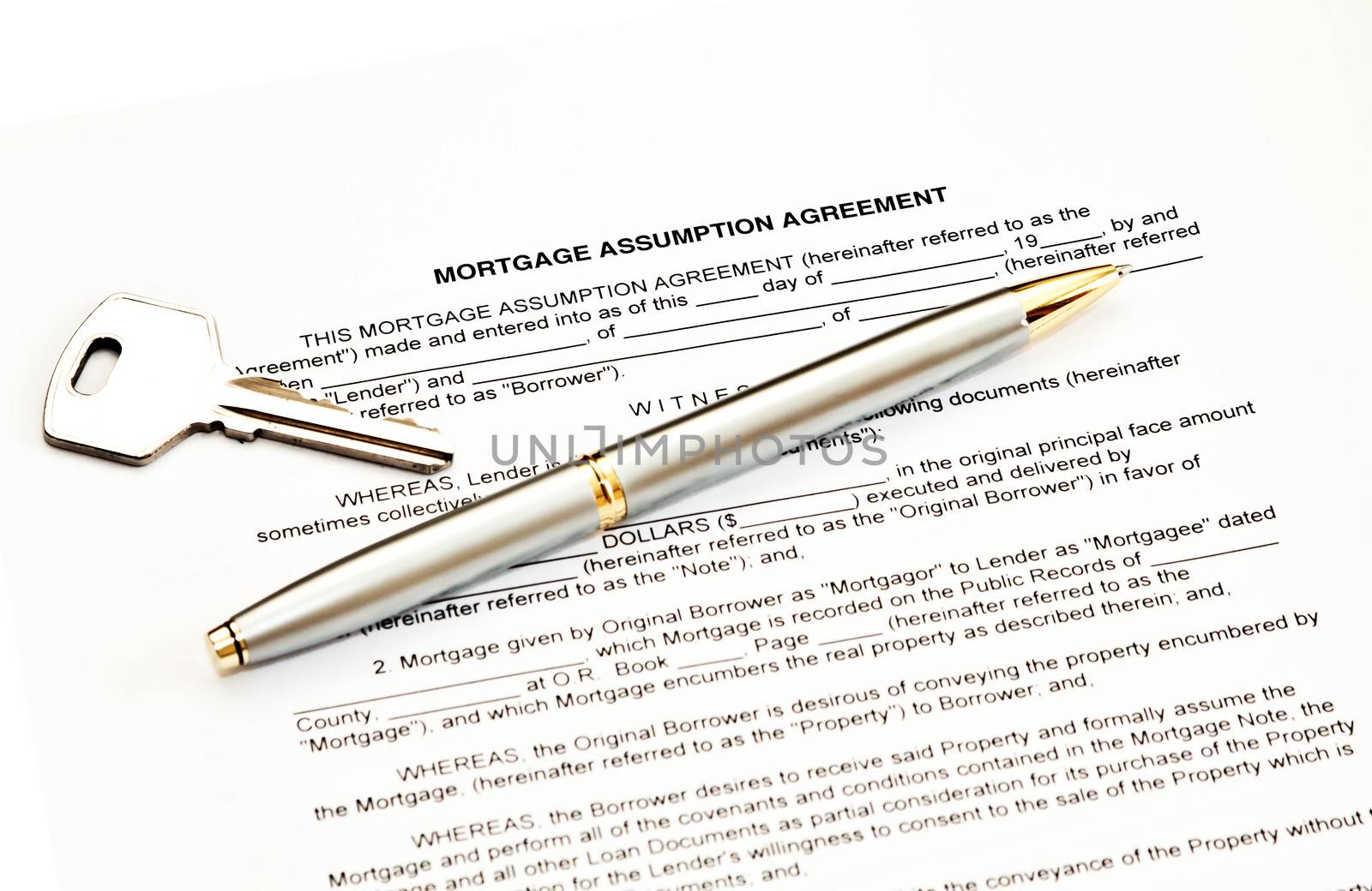 Mortgage assumption agreement with a pen for signature and a key
