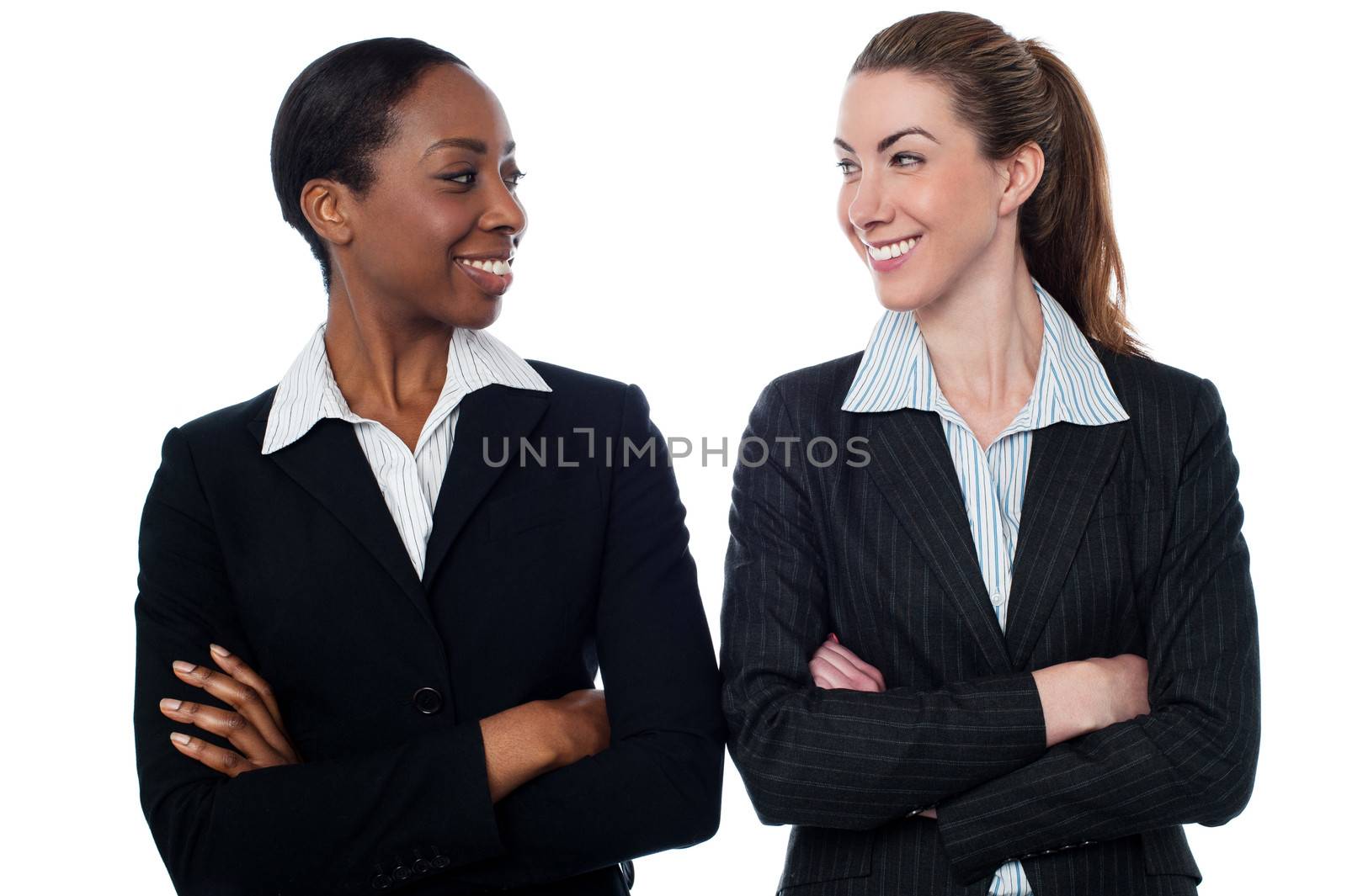 Attractive smiling female executives by stockyimages