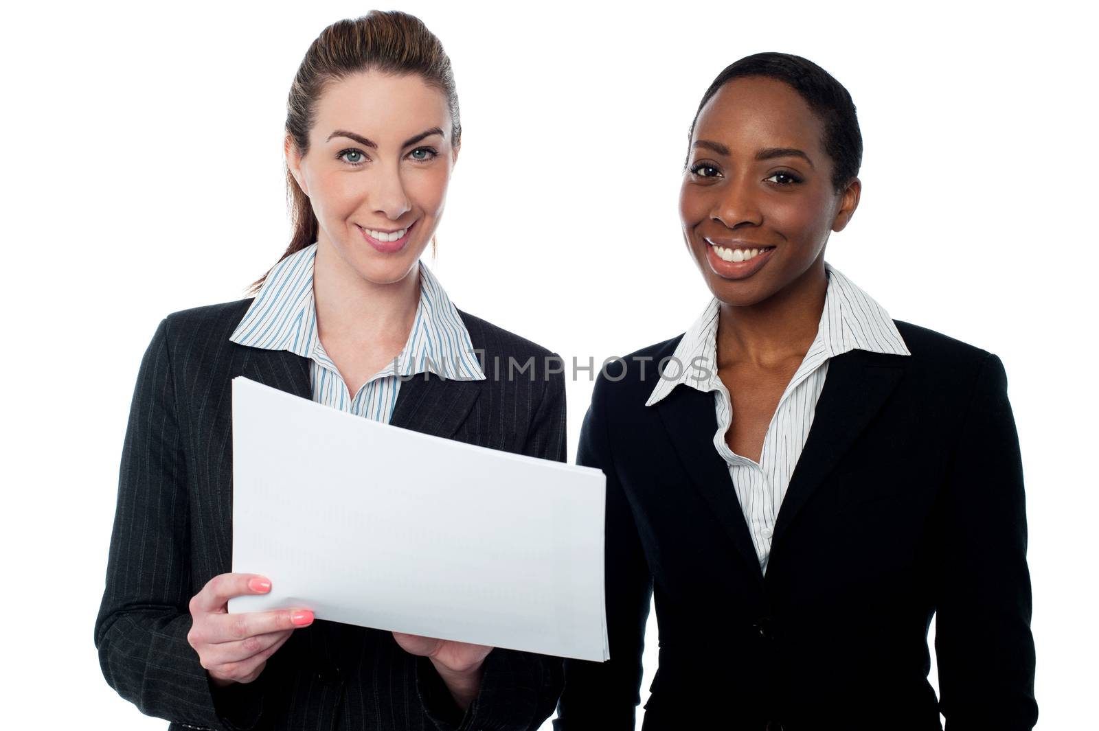 Corporate ladies reviewing reports by stockyimages