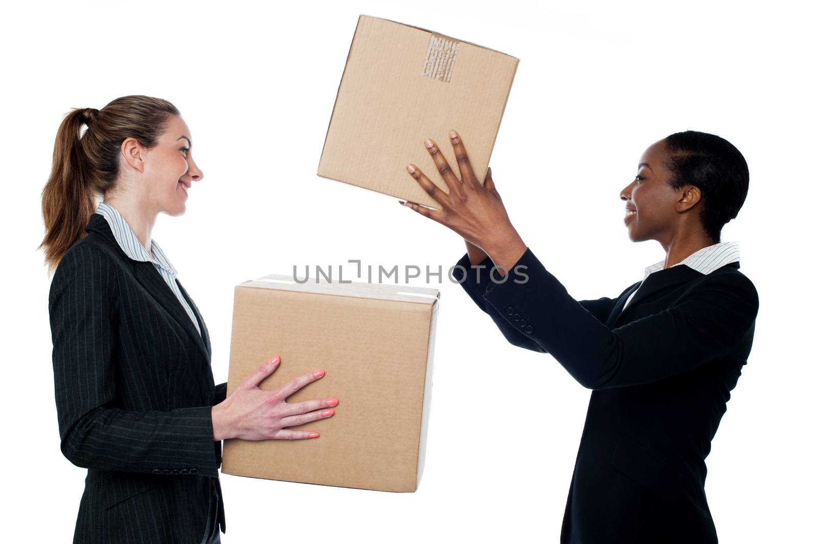 Businesswoman passing packed cartons