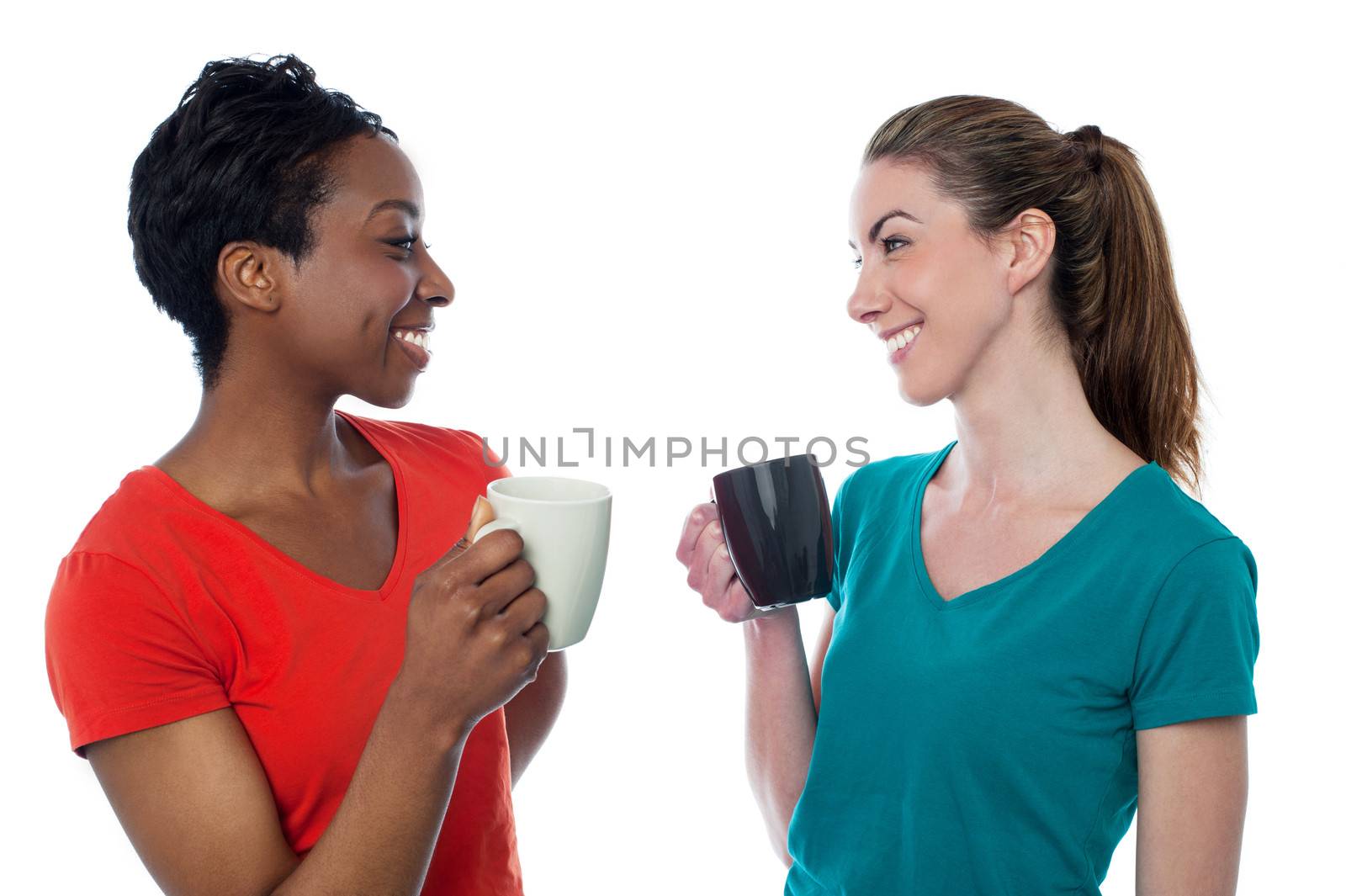 Casual women enjoying coffee by stockyimages