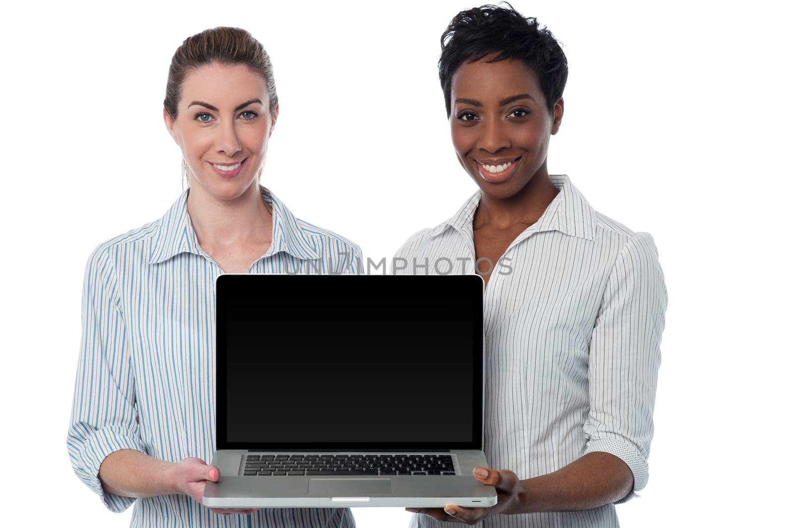 Saleswomen presenting brand new laptop by stockyimages