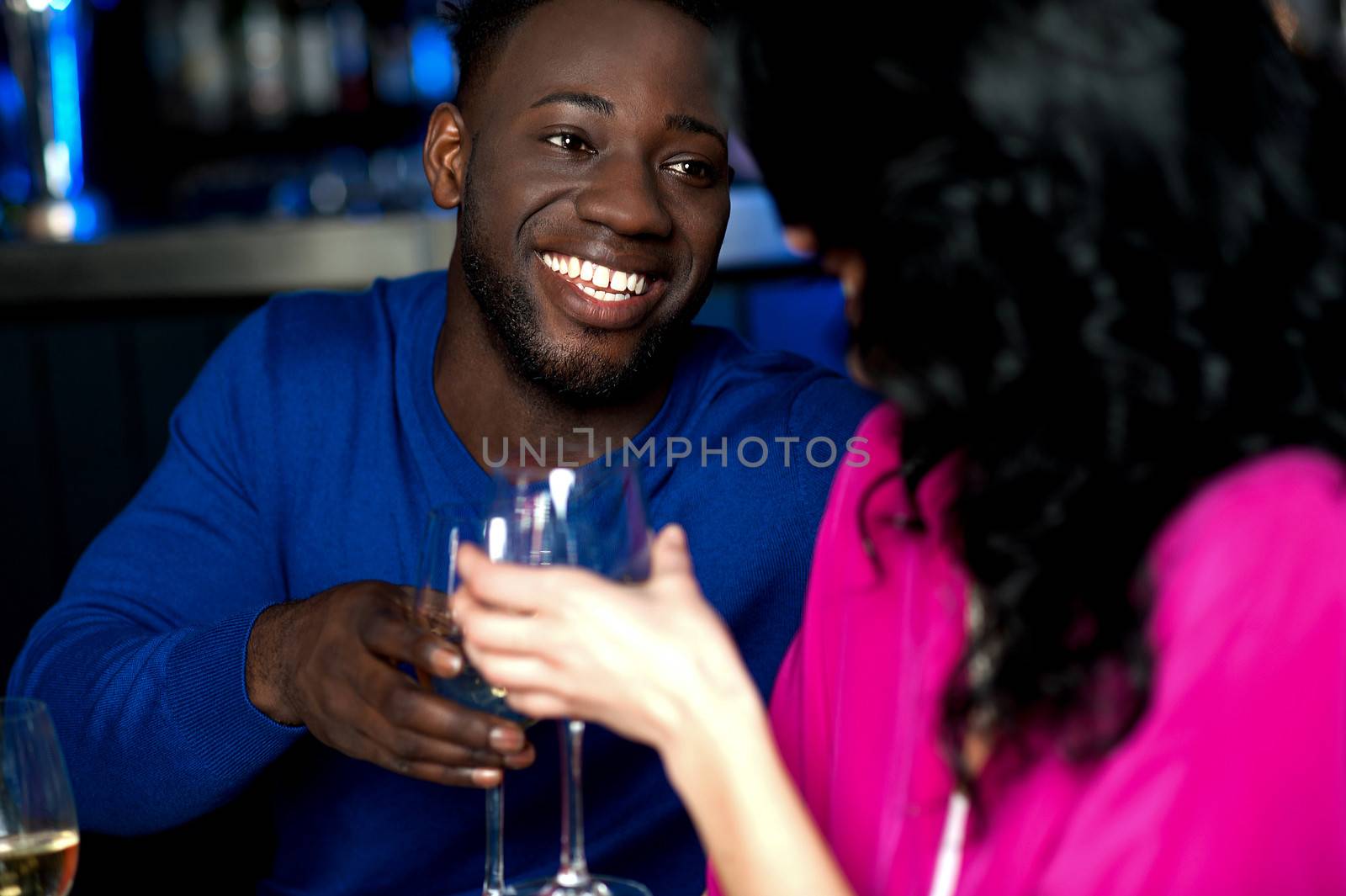 Affectionate romantic couple in a bar by stockyimages