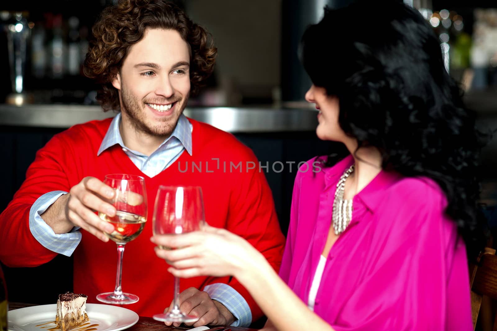 Happy young couple toasting in love, cheers!