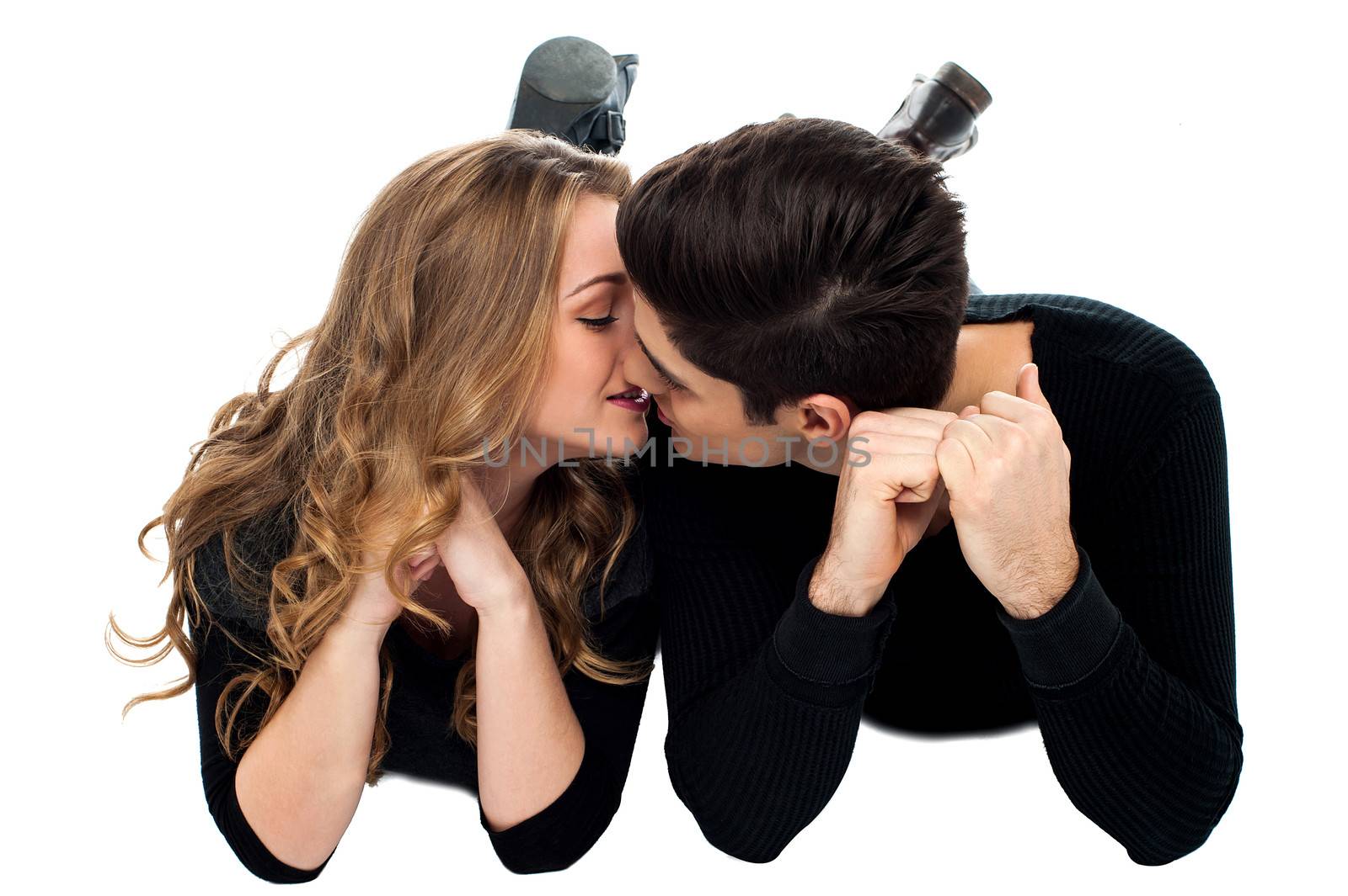 Adorable young couple kissing by stockyimages