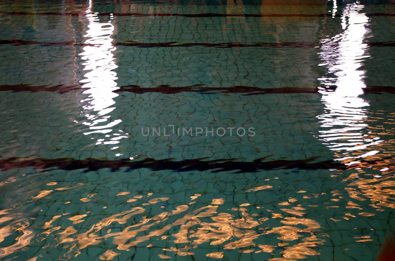 Sunlight and natural light reflect of surface and bottom of swimming pool