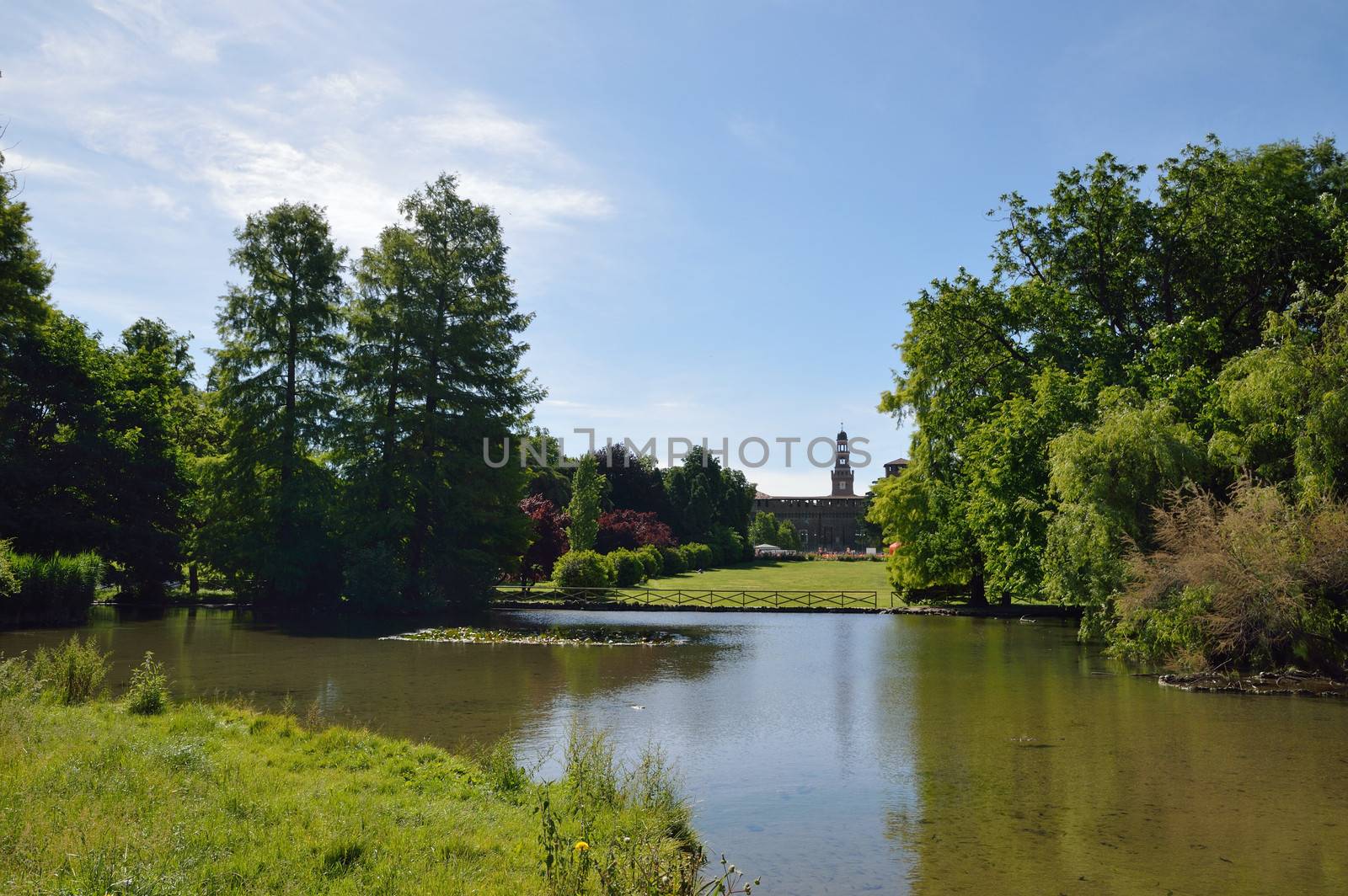 City park in Milan with lake and Sforza castle behind