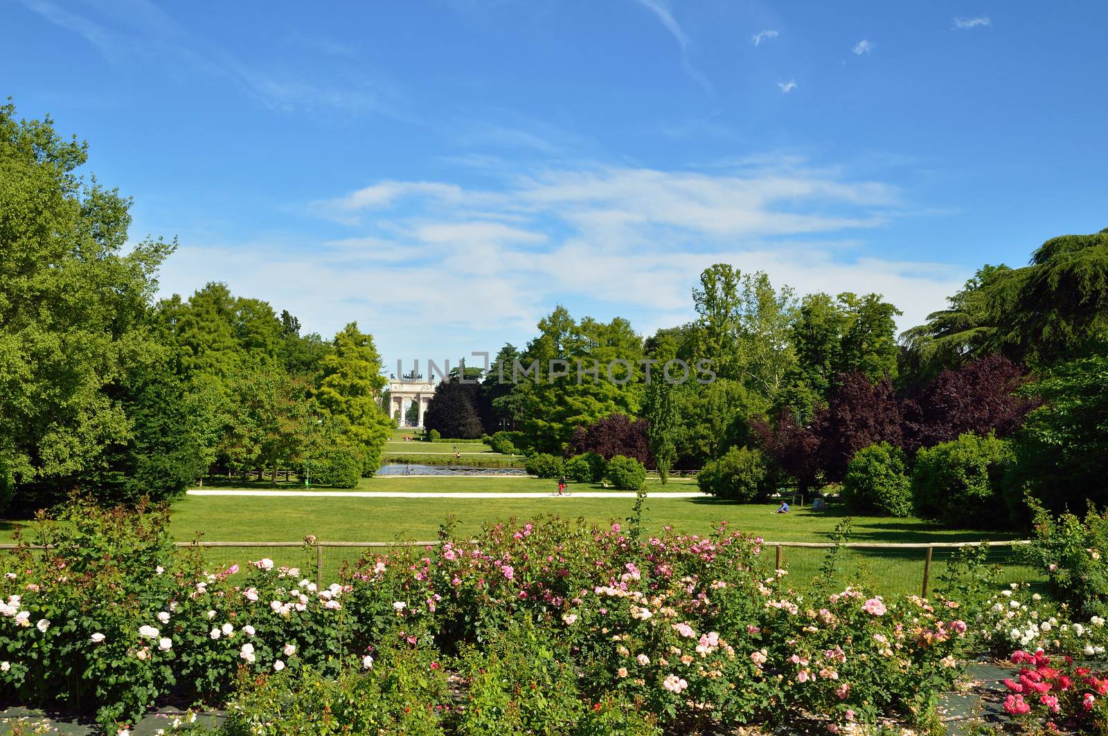 City park in Milan with roses and triumphal arch behind