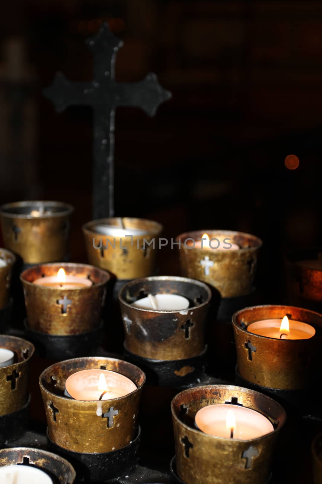 Candles in a church on black background.