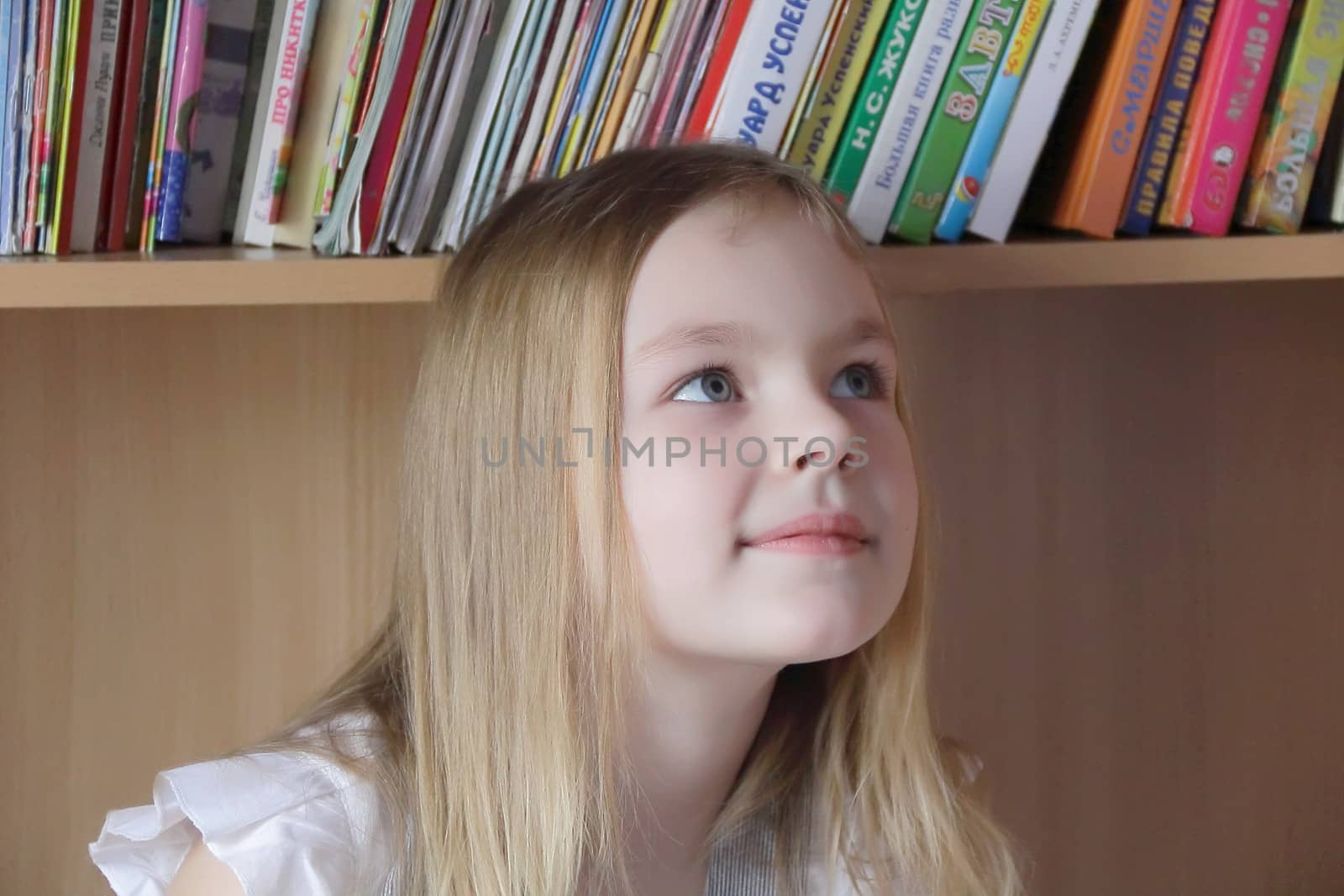 Portrait of beautiful girl on book background