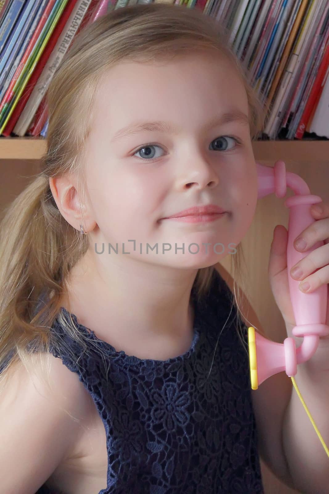 Portrait of beautiful girl with pink telephone