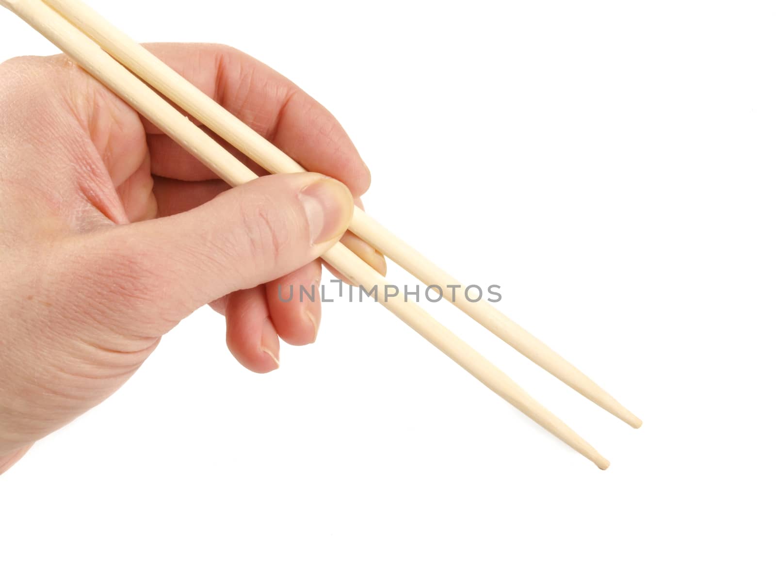 Person holding a pair of wooden chopsticks towards white background