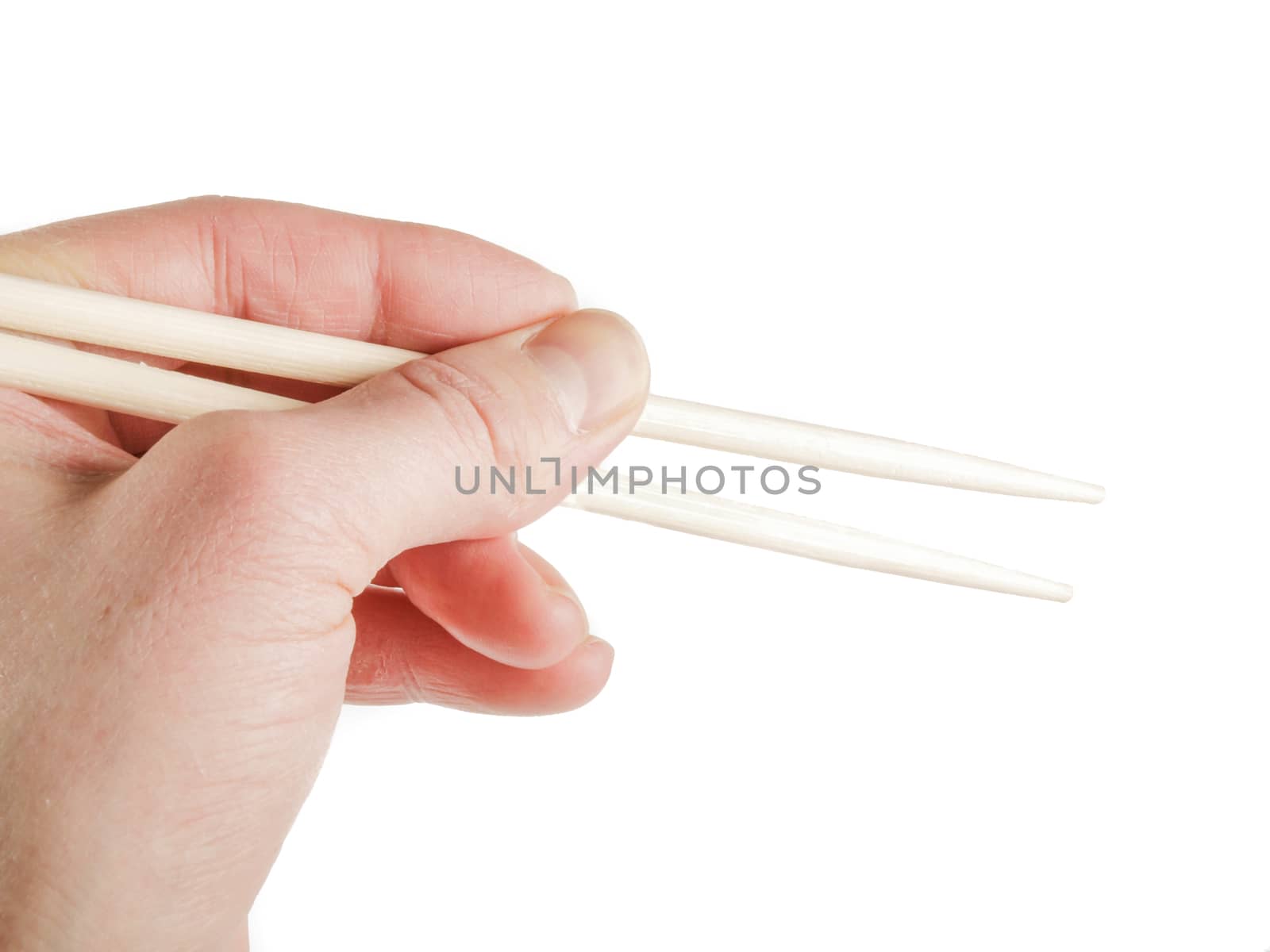 Person holding a pair of wooden chopsticks towards white background