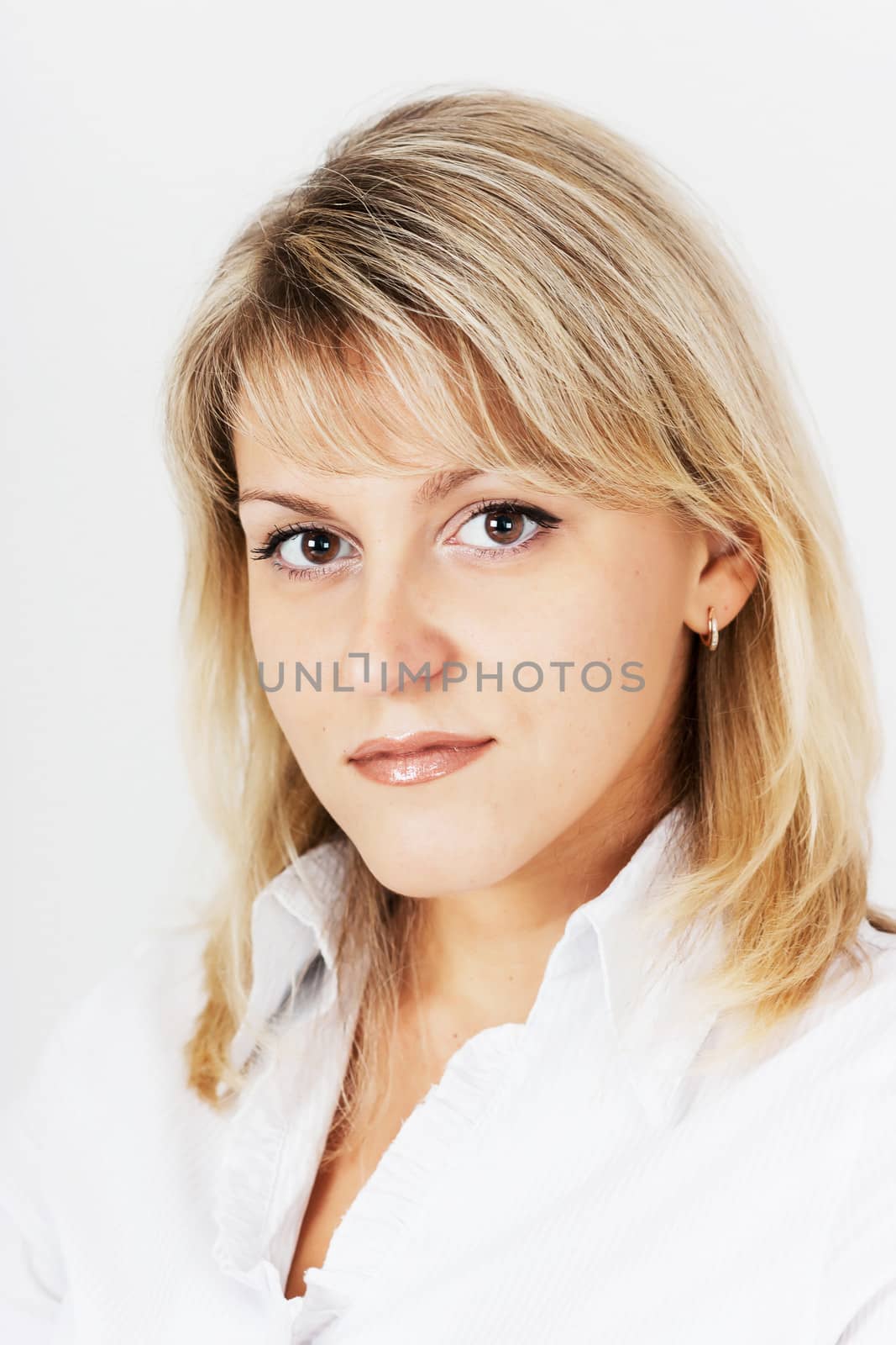 portrait of an attractive blonde girl on a light background