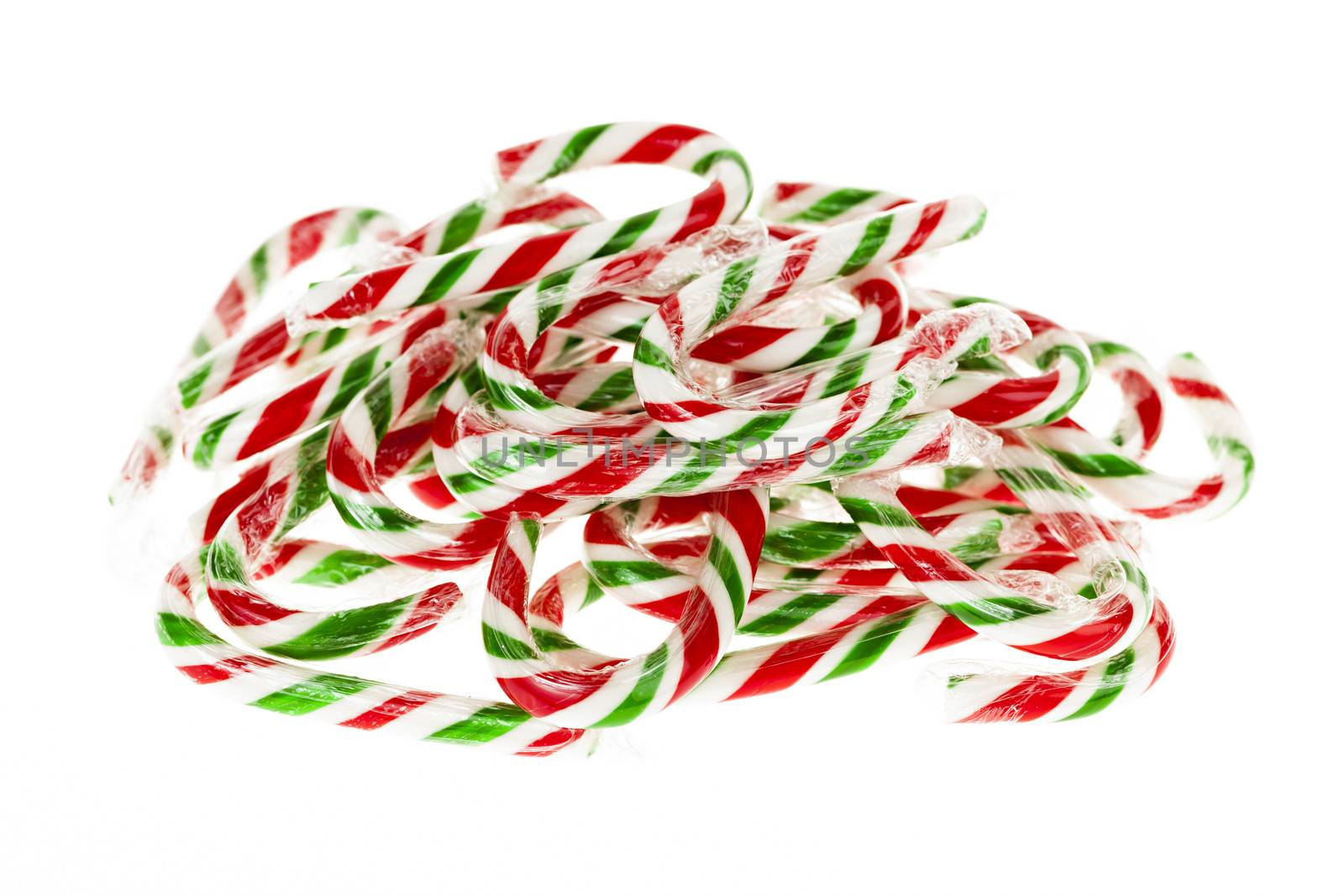 Pile of red and green Christmas candy canes isolated on white background