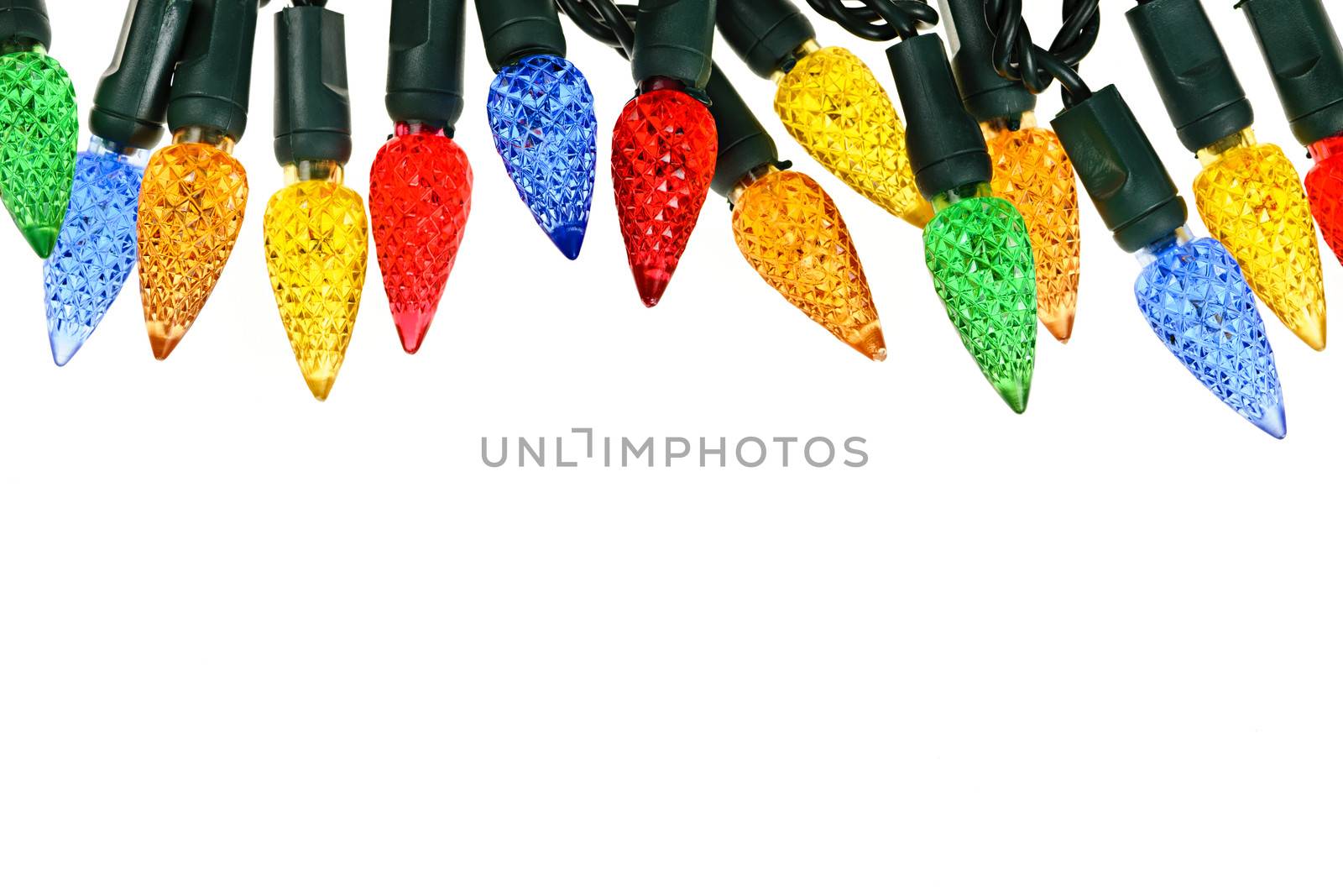 Multicolored string of Christmas lights isolated on white background