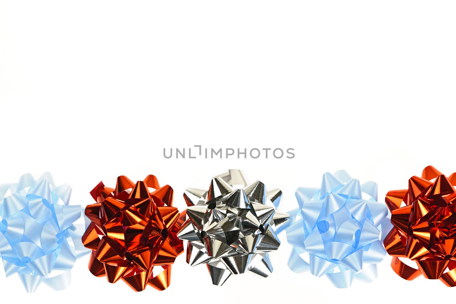 Row of multicolored gift wrapping bows isolated on white background