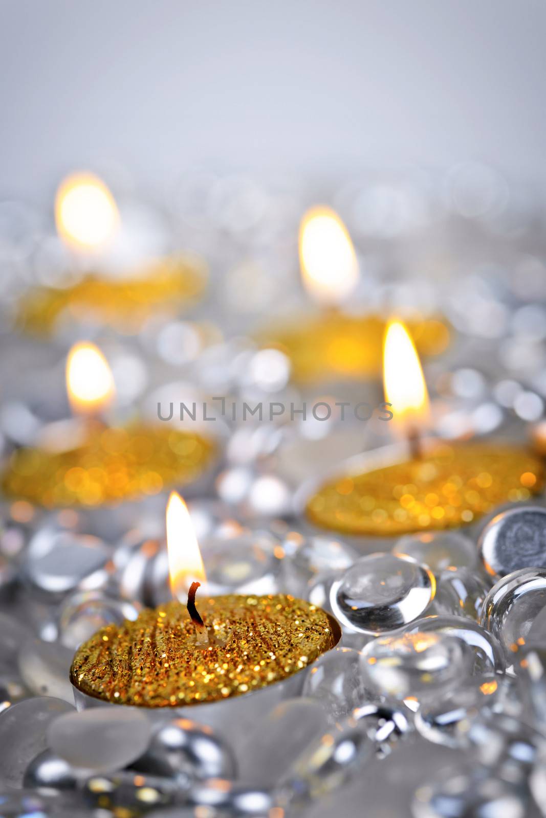 Burning golden decorative Christmas candles with glass beads