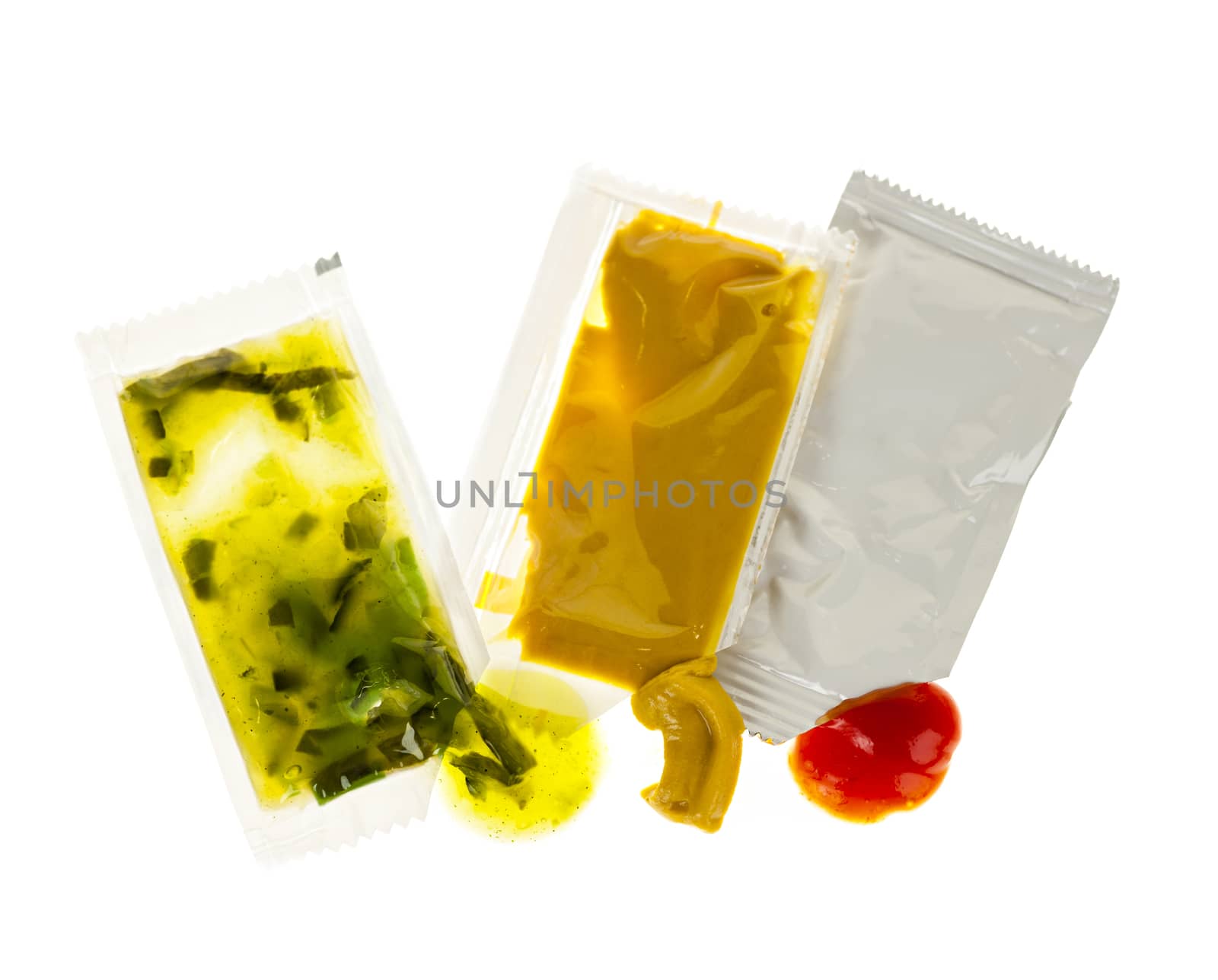 Relish mustard and ketchup condiment packets open on white background