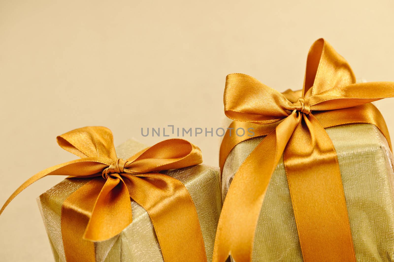 Two golden wrapped gift boxes by elenathewise