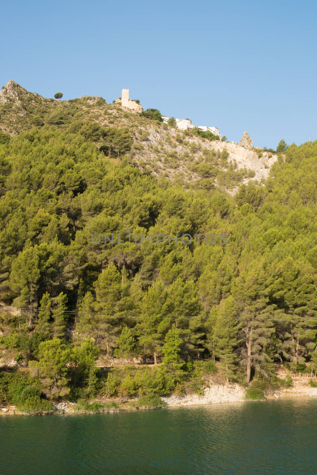 Hilltop castle of Guadalest above the calm waters of a lake