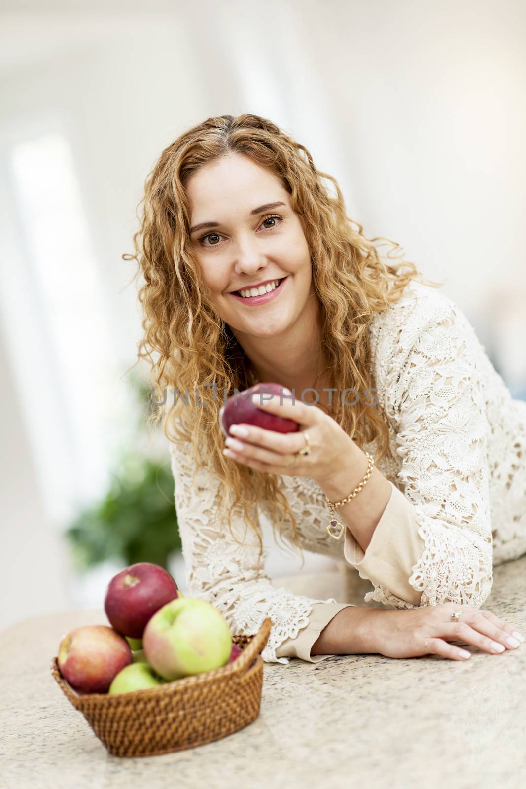 Smiling woman holding apple by elenathewise