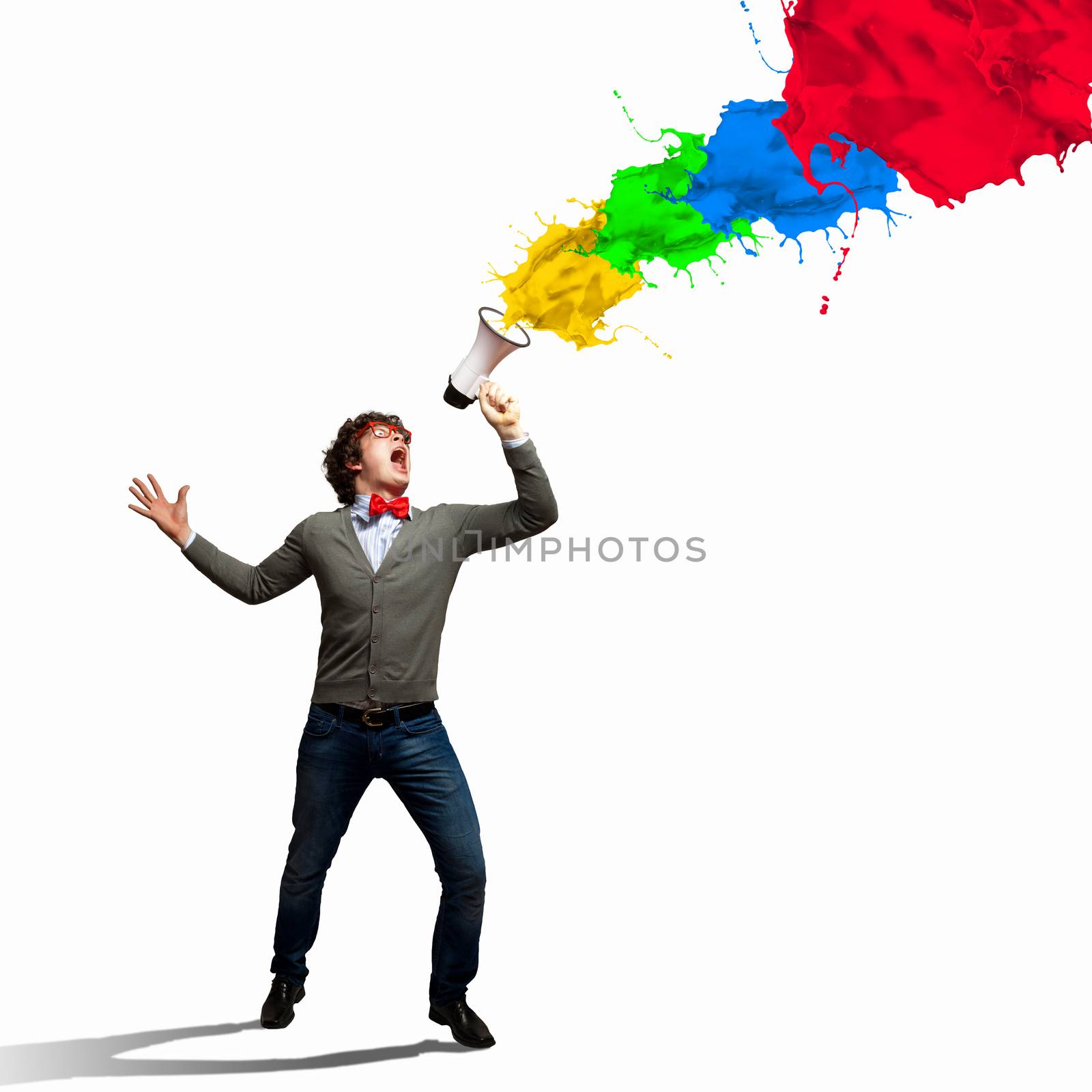 Portrait of young man shouting loudly using megaphone