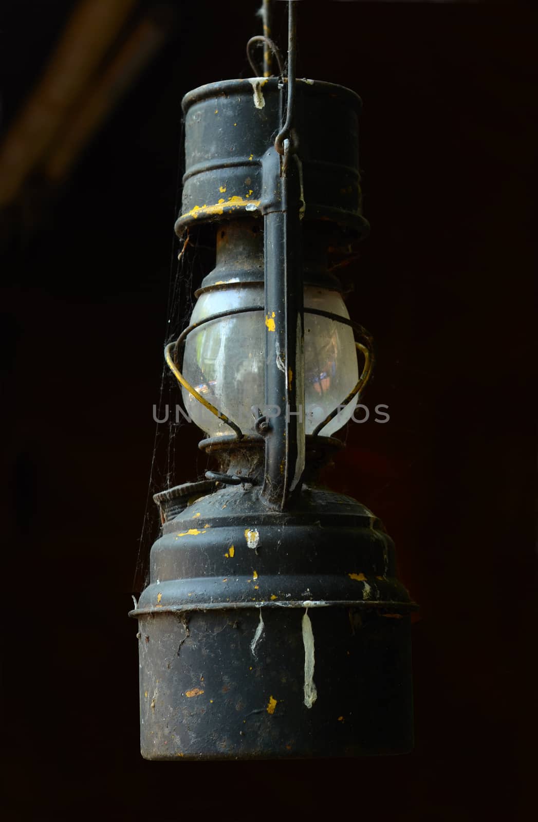 A Grungy Vintage Oil Lamp Hanging In A Barn