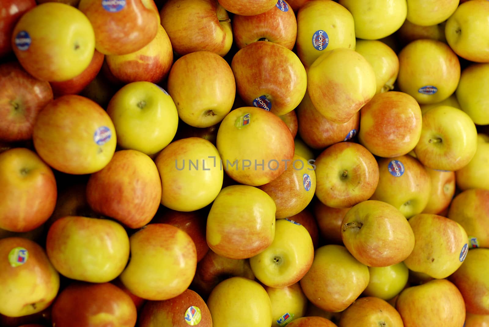 Yummy pile of apples in a market stall by stockyimages