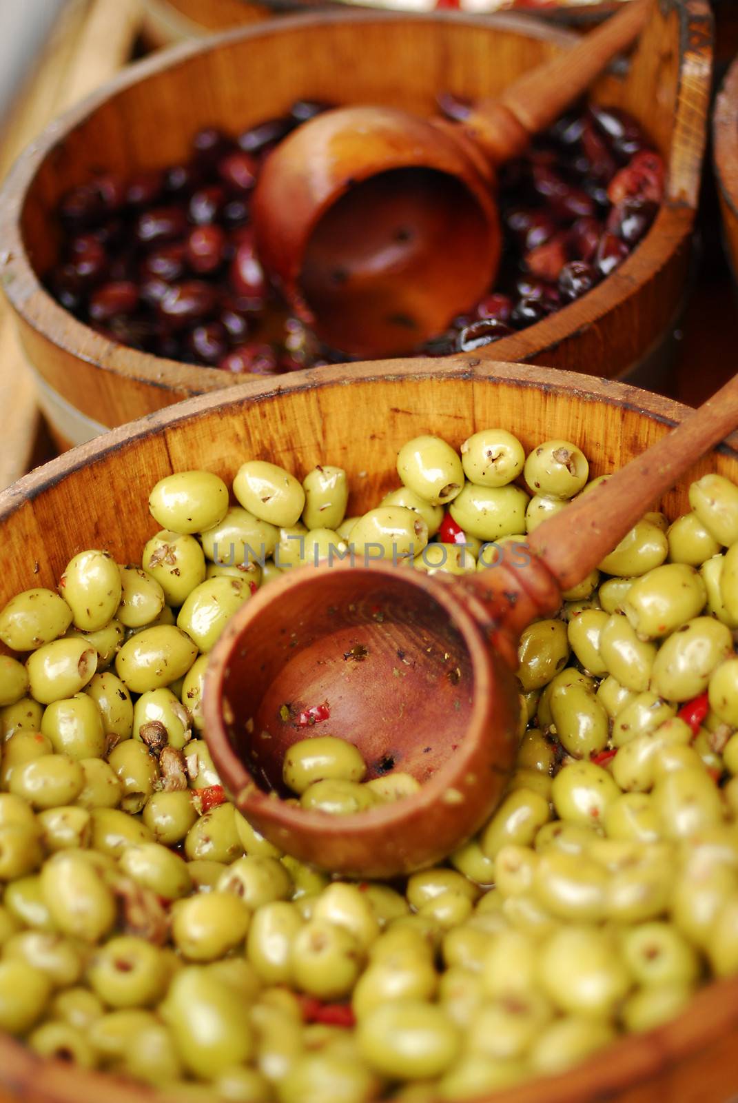 Variety of olives being sold at a market by stockyimages