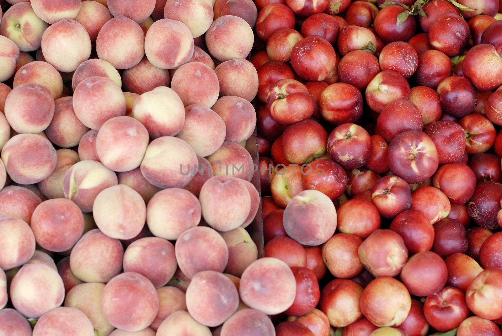 Yummy pile of apples for sale in a market stall by stockyimages