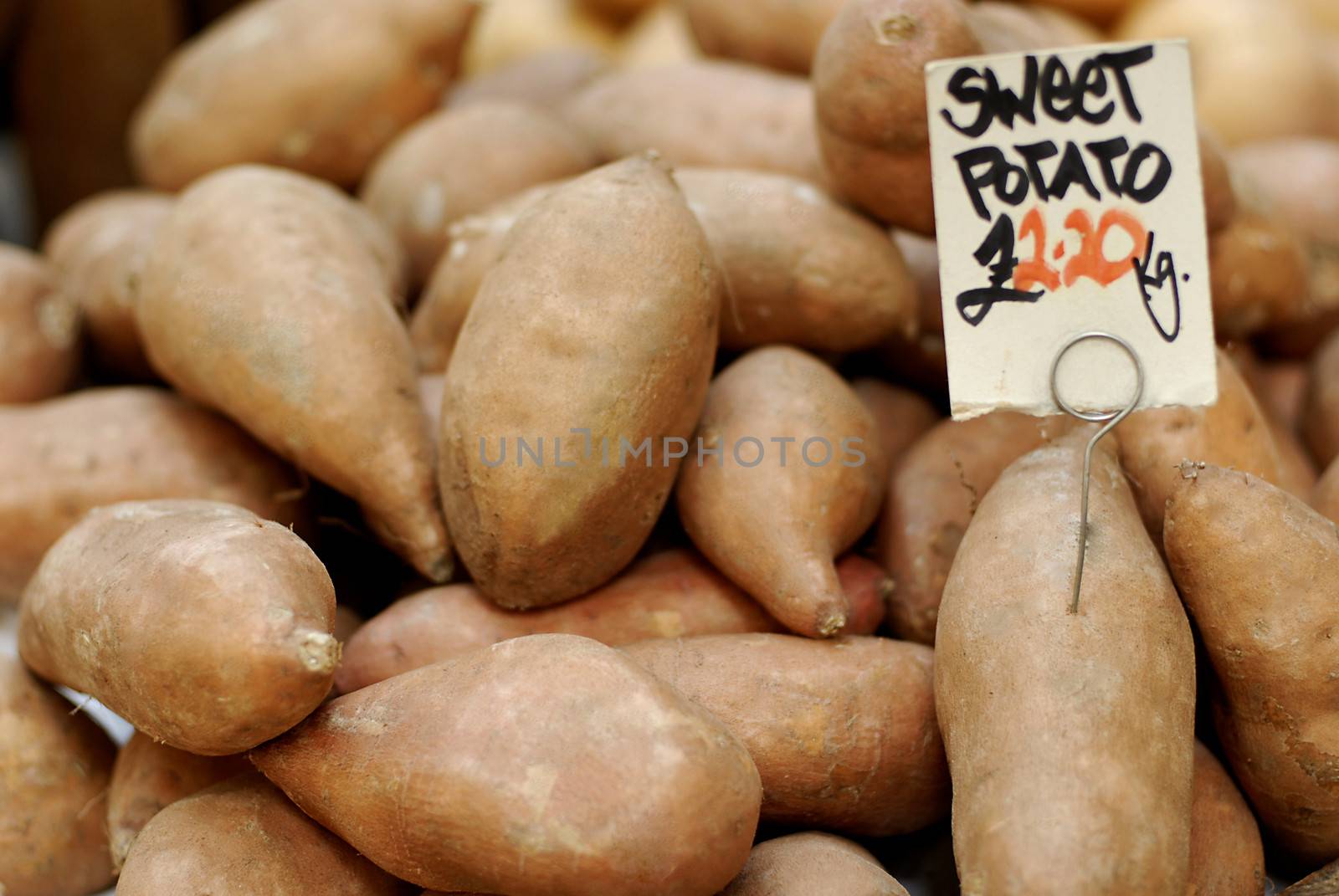 Sweet potatoes at a farmers market priced at 2.20 euro per kg