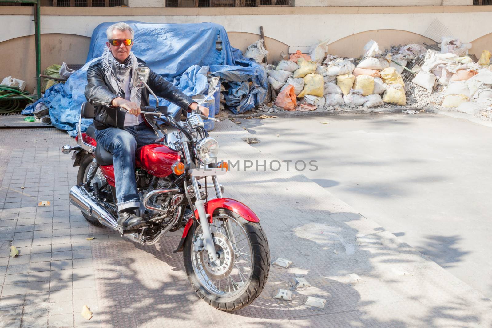 senior caucasian bike rider red cruiser builder yard by arfabita
