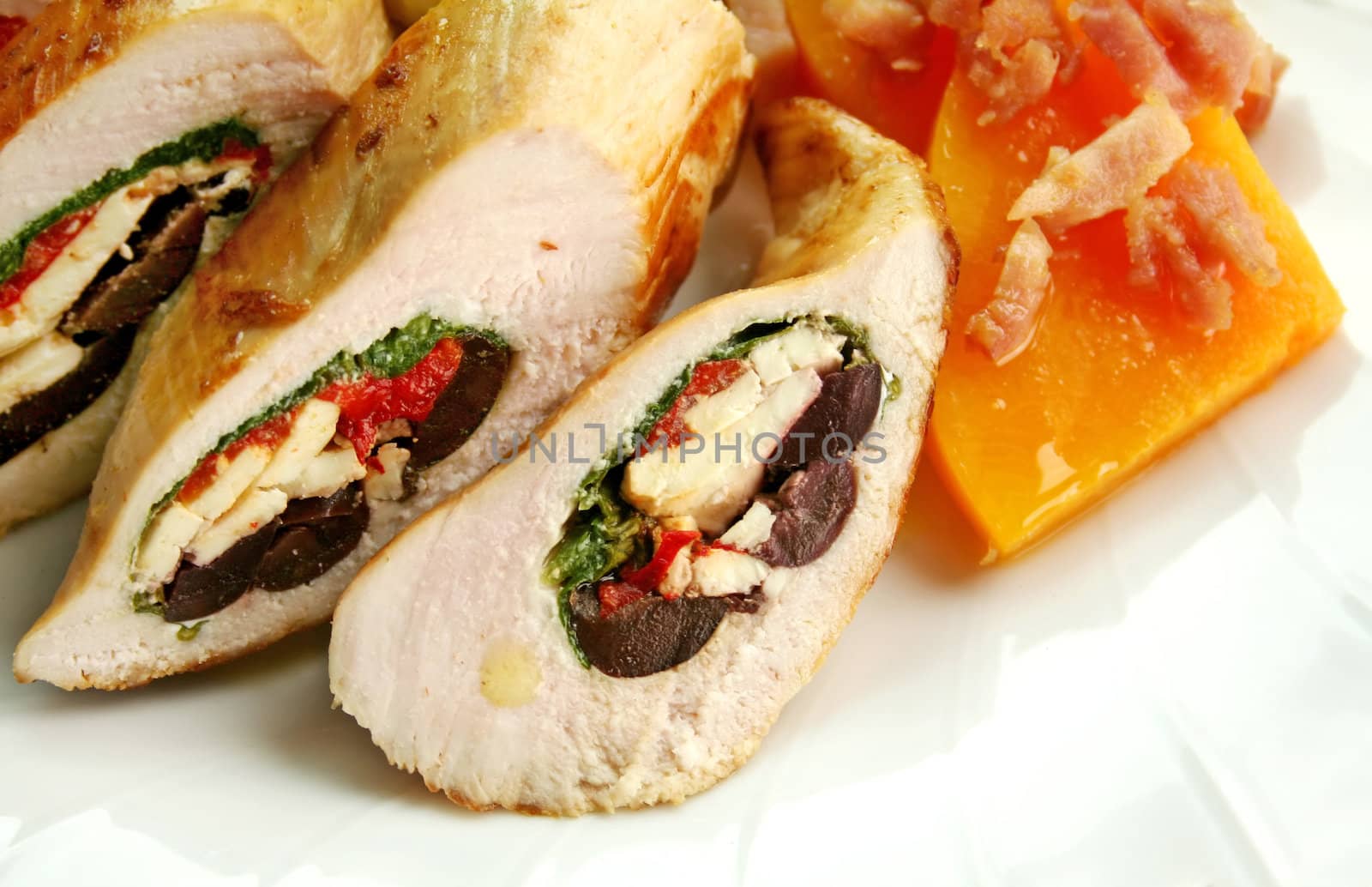 Chicken stuffed with a Mediterranean filling made of spinach, fetta, peppers and olives with vegetables.
