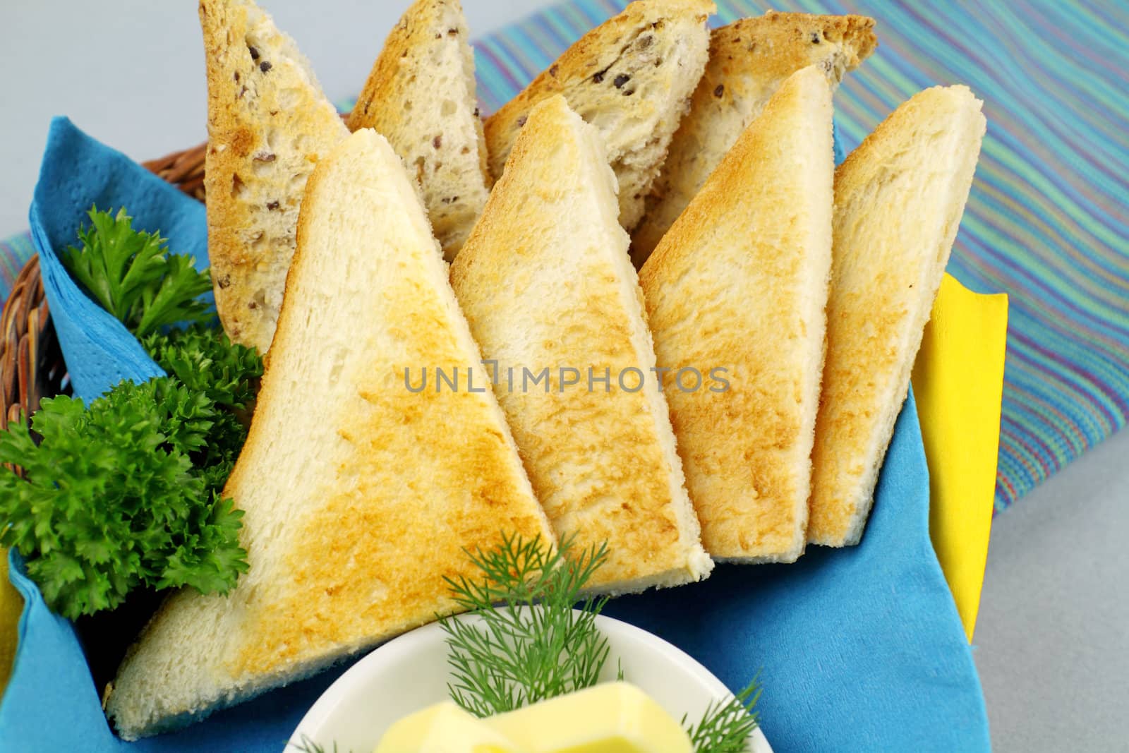 Crisp toast quarters with butter and Italian parsley.