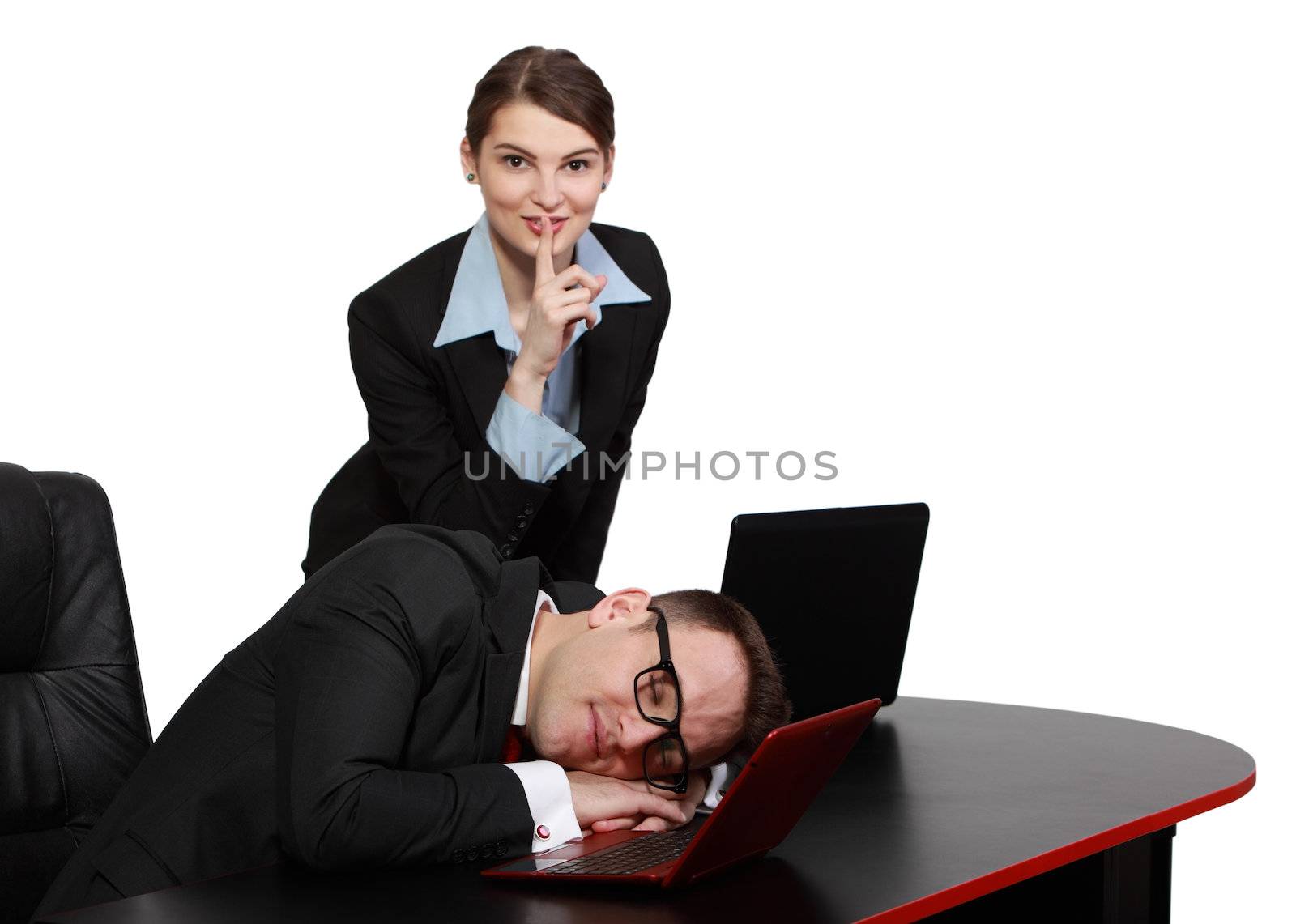 The secretary keeps silence while her tired boss dozing on the desk in front of his noteboook.