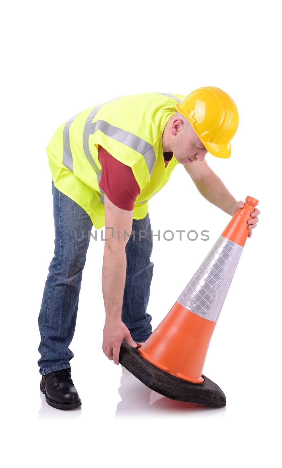 Construction worker setting out a traffic cone  isolated on white