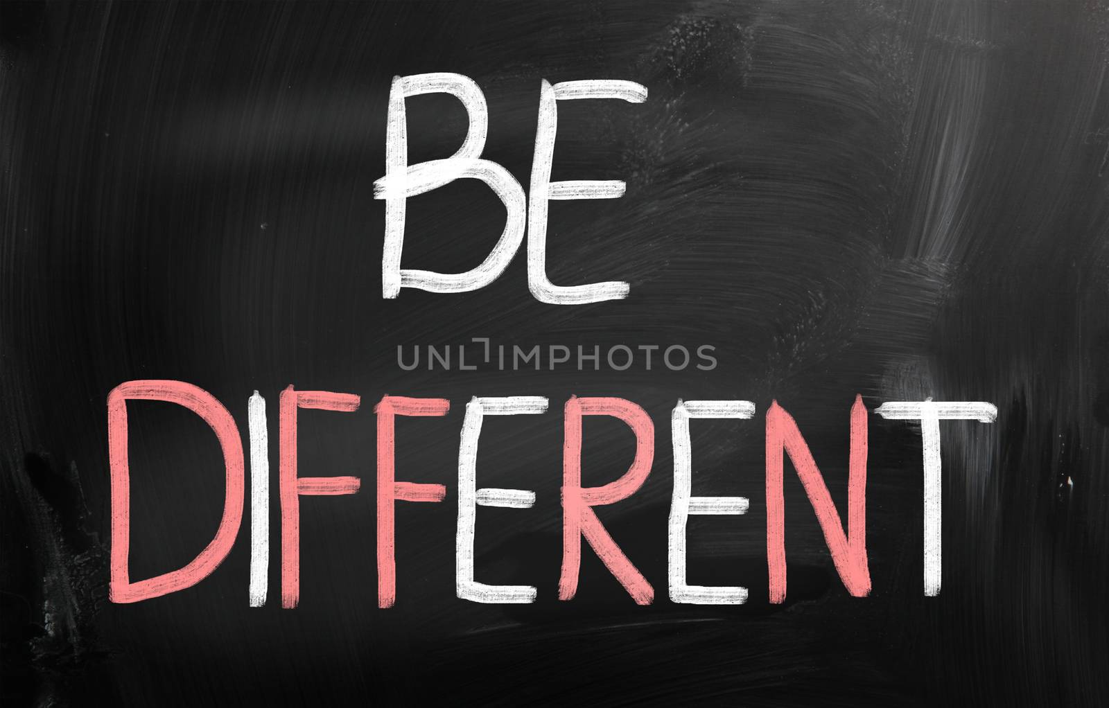 Be different handwritten with chalk on a blackboard