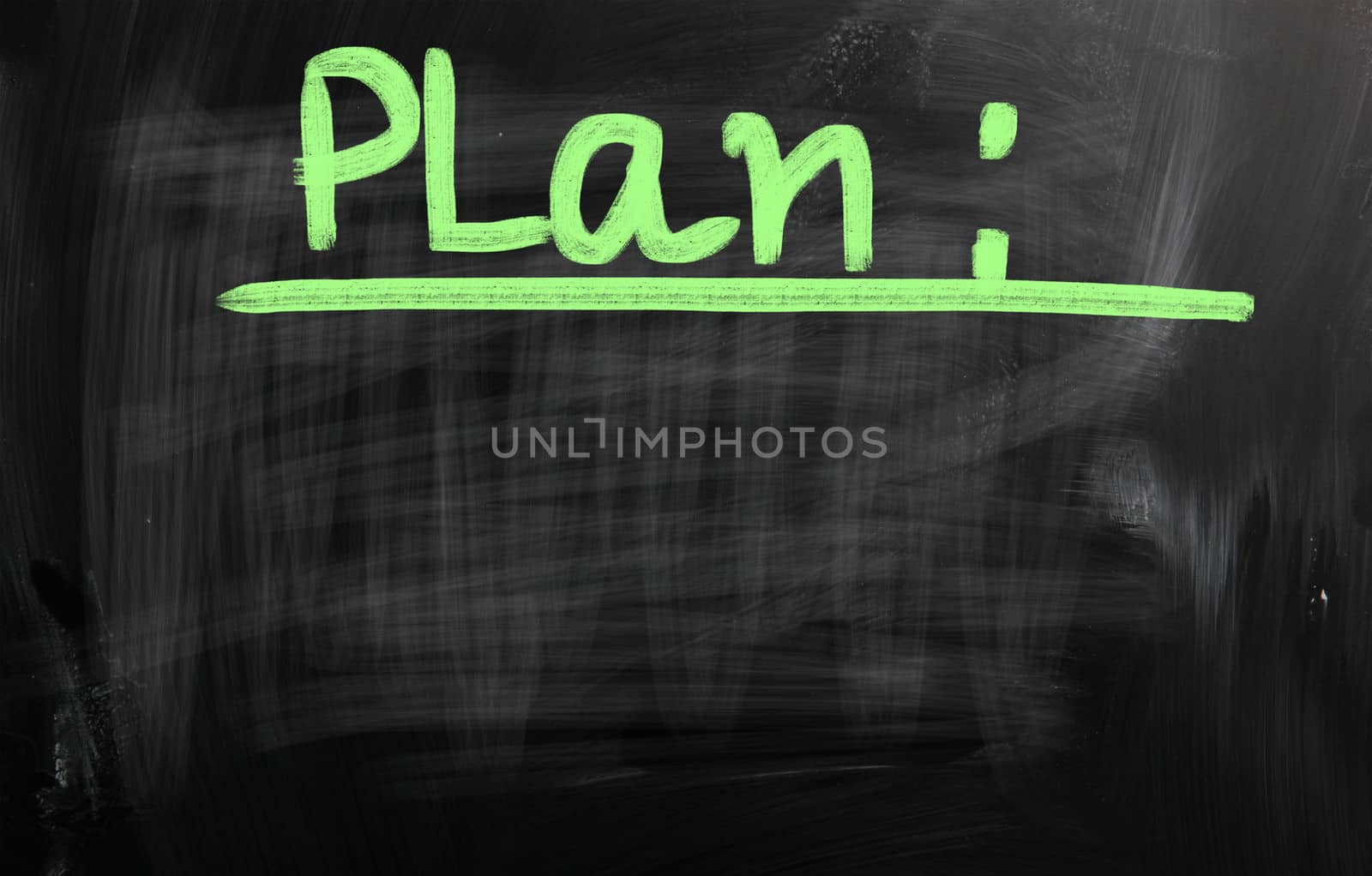 "Business plan" handwritten with white chalk on a blackboard.