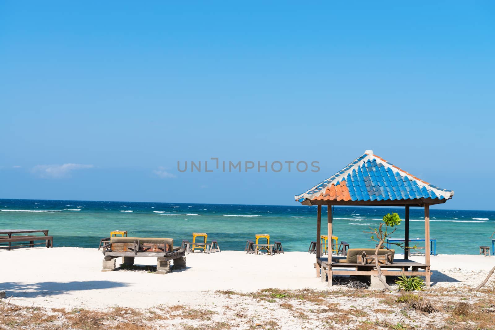 Beautiful beach with blue clean water and seaside cafe on tropical beach. 