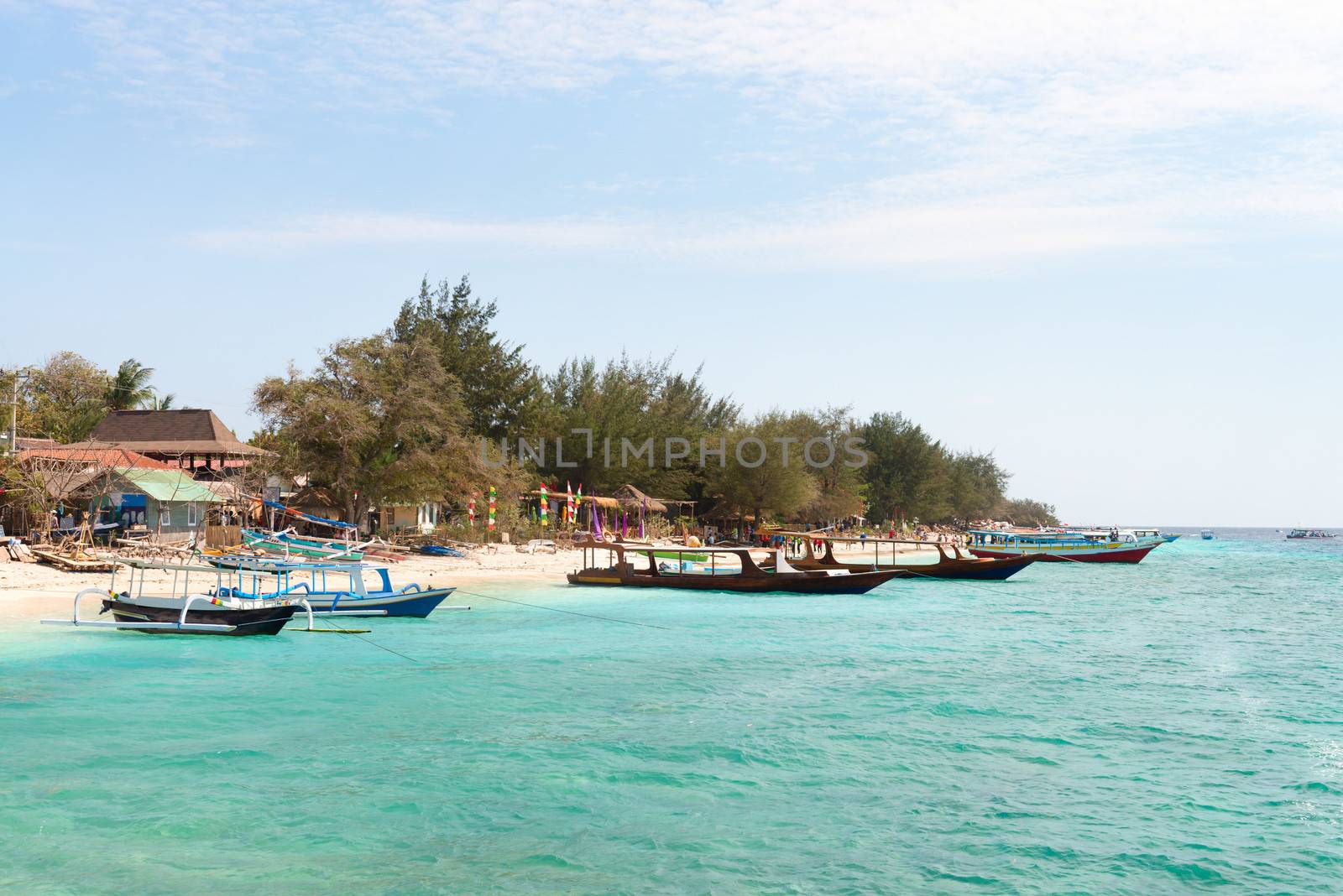 Small wooden tourist and fishing long boats near sand beach, Gili Trawangan island, Indonesia 