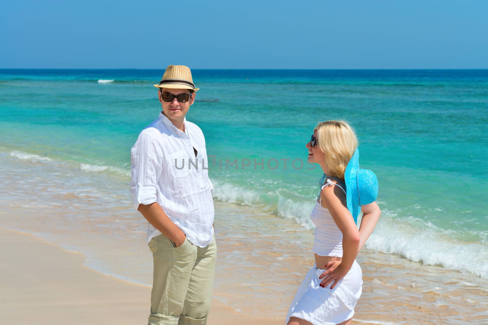 Happy young couple enjoying at beach by iryna_rasko