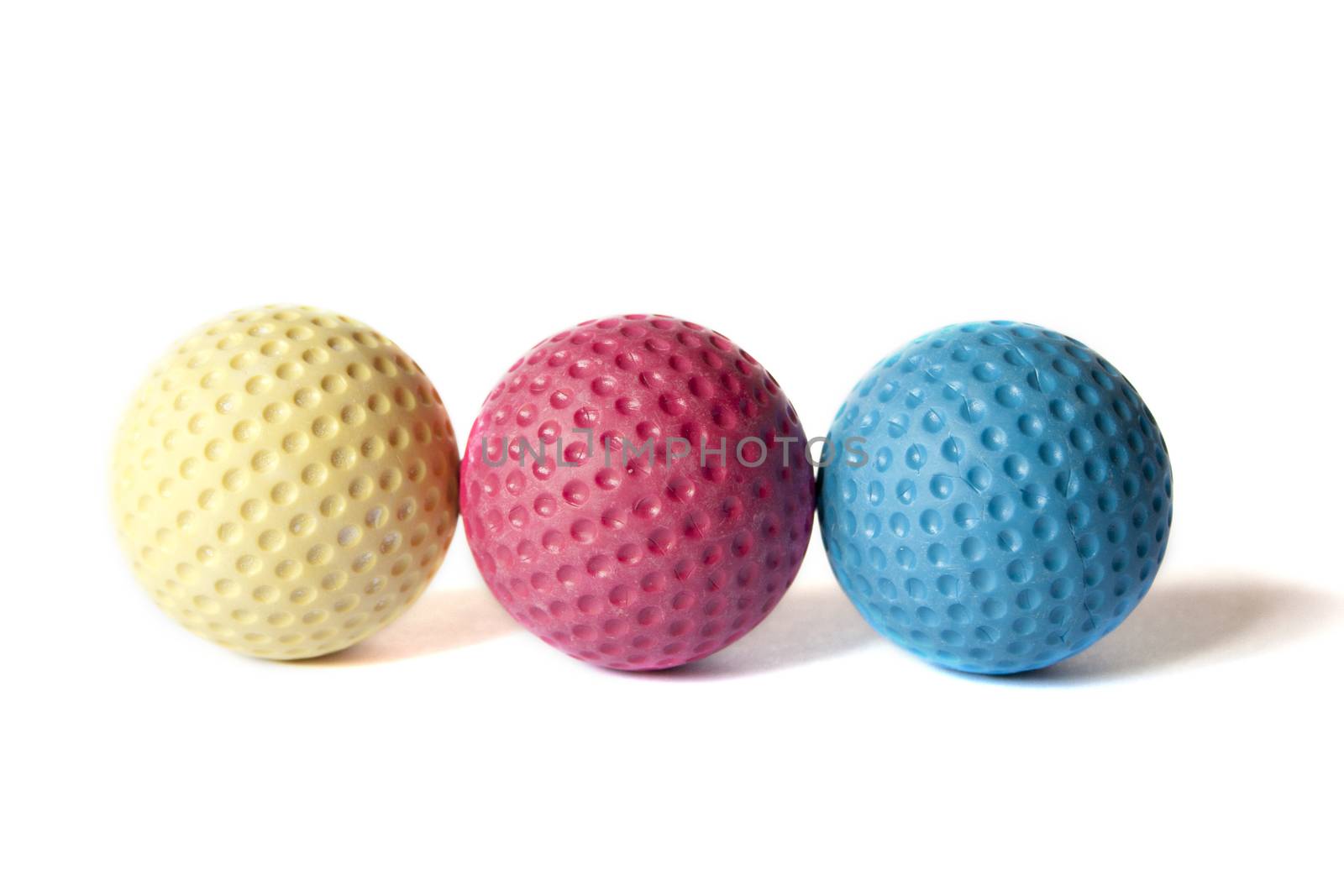 Yellow, Red and Blue colored Mini Golf balls on an isolated background