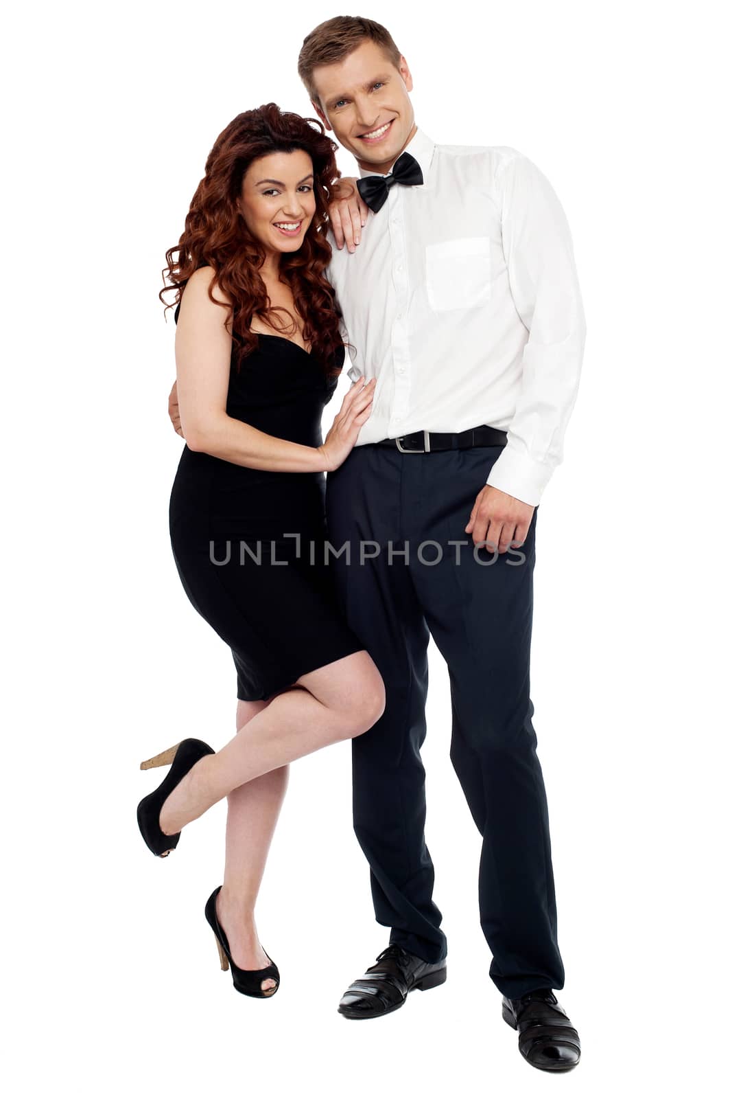 Full length portrait of attractive couple dressed in party wear attire. Isolated against white