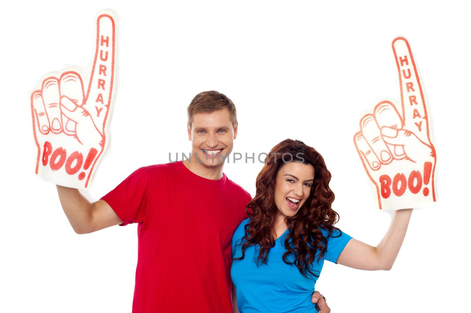 Young couple showing boo hurray foam hand to camera, excited couple