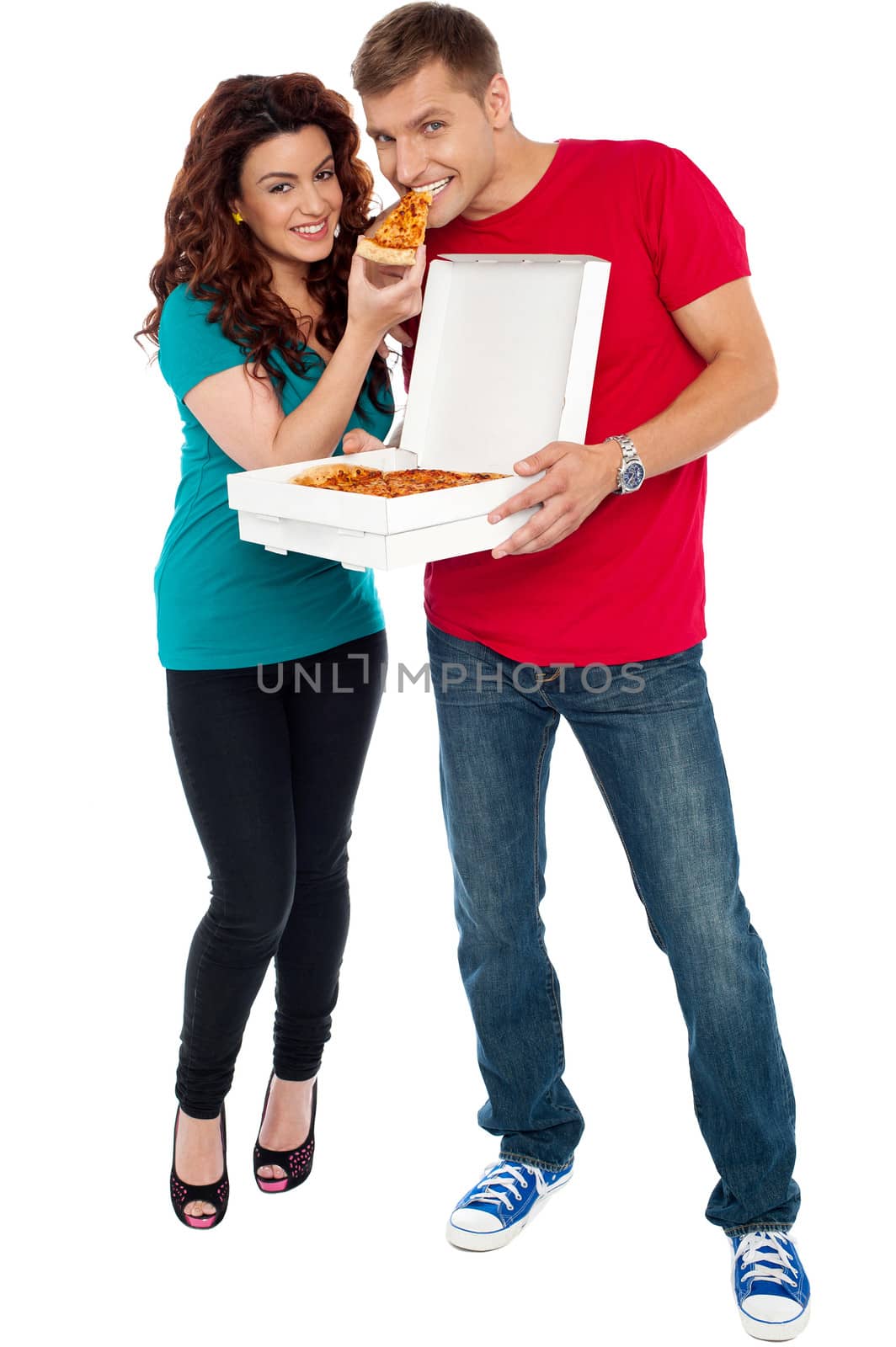 Couple enjoying pizza together, great bonding. Full length shots