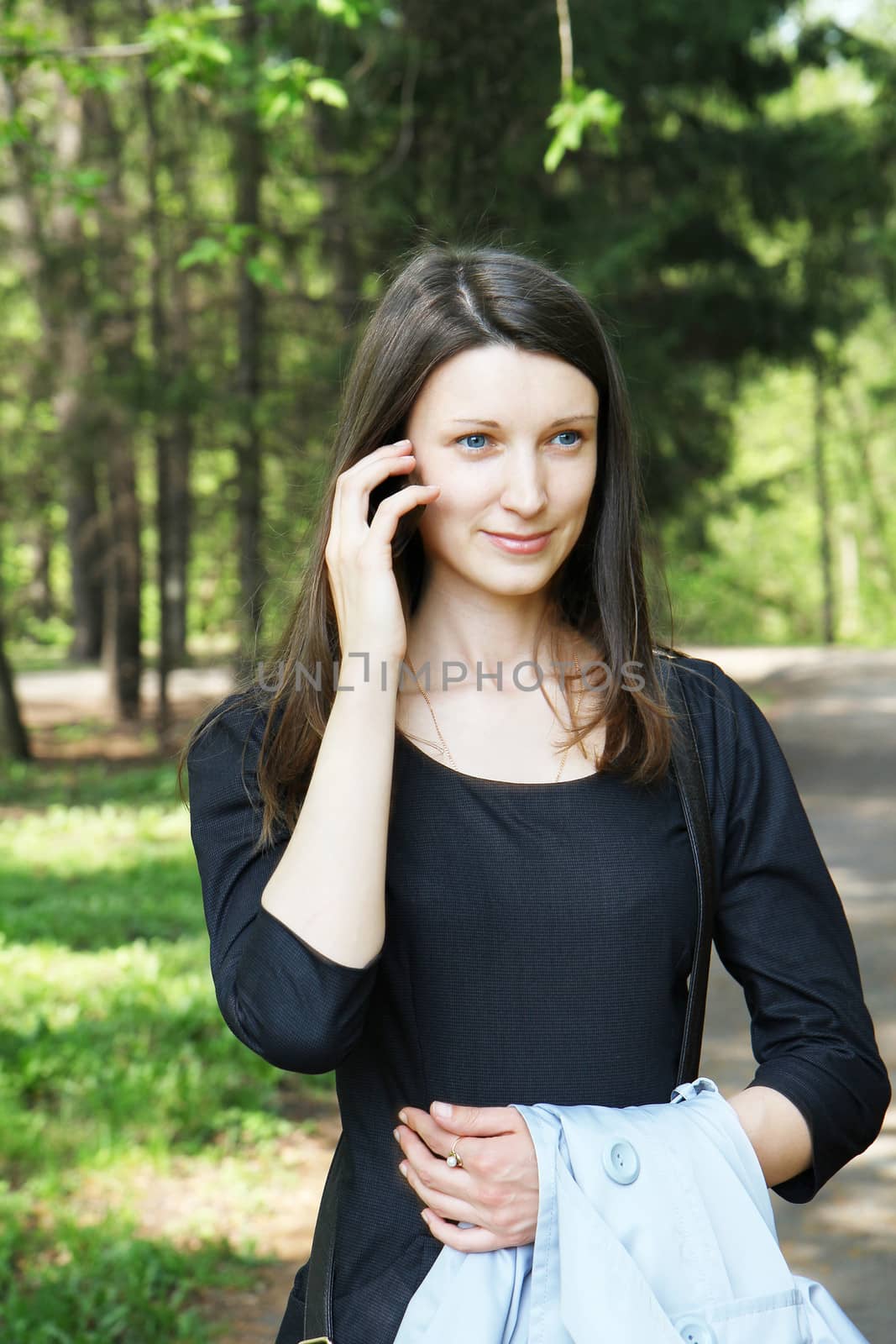 beautiful girl talking by mobile phone, in summer
