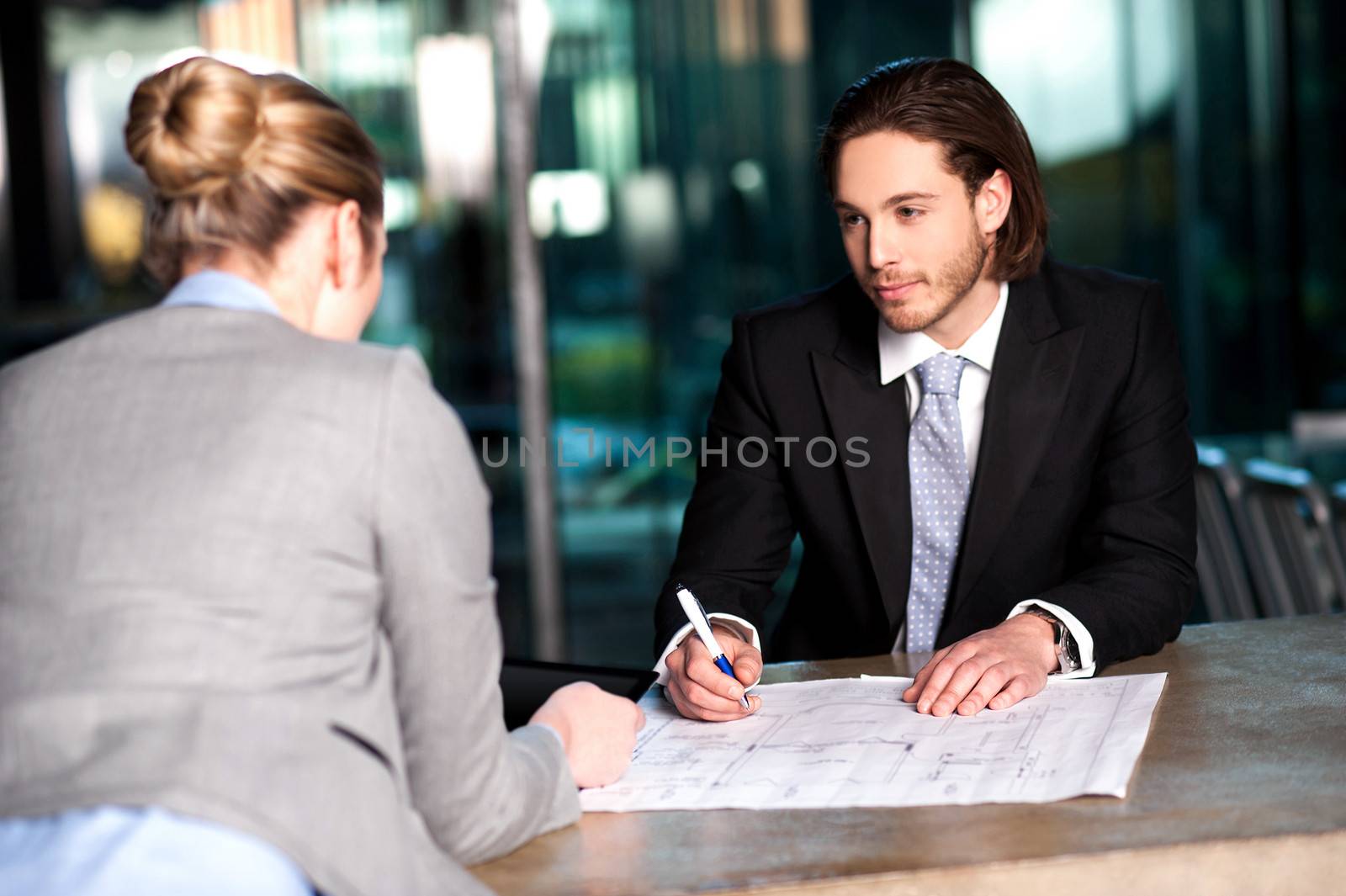 Colleagues discussing business plan by stockyimages